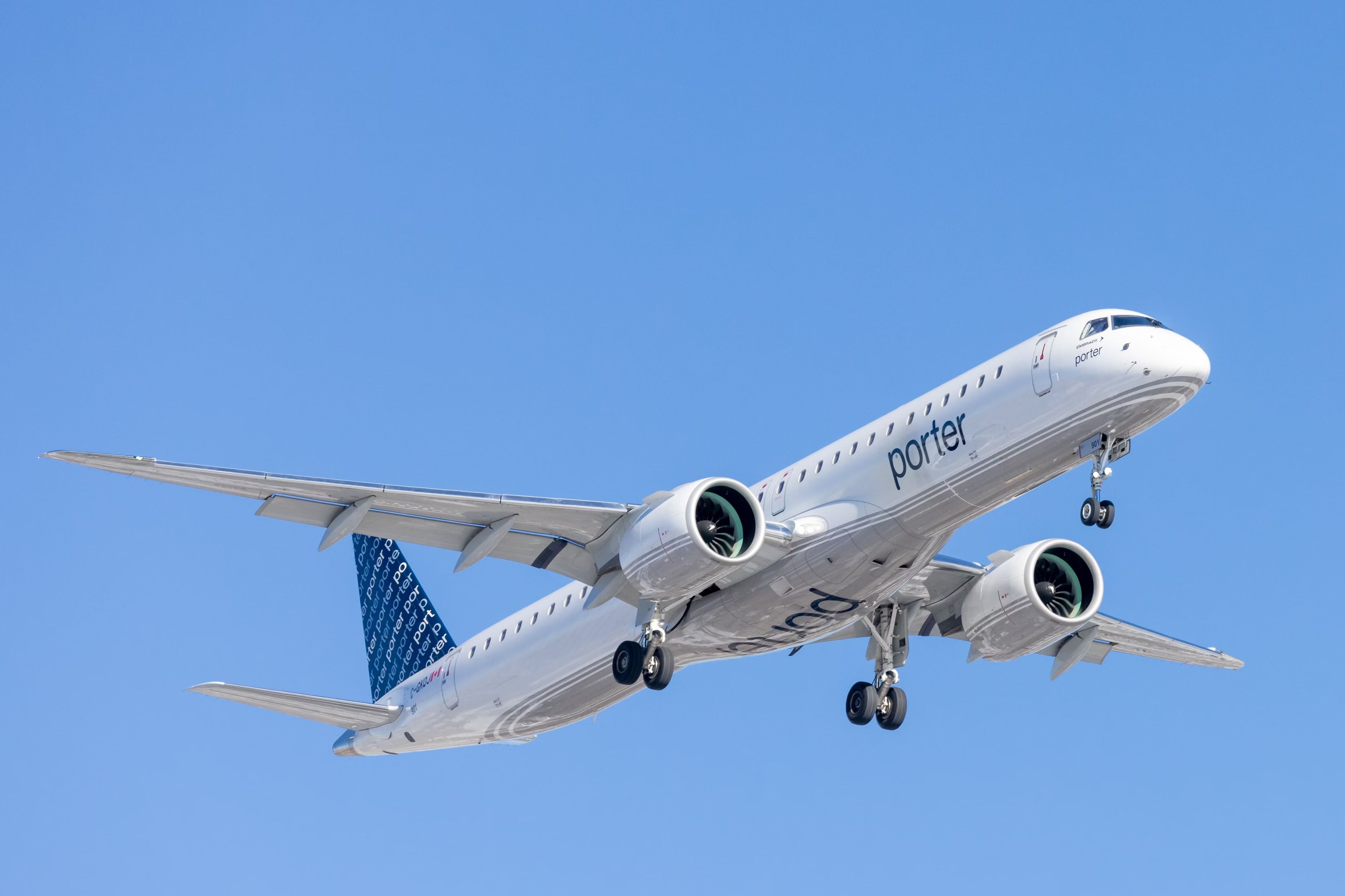 A Porter Airlines Embraer E195 flying in the sky.
