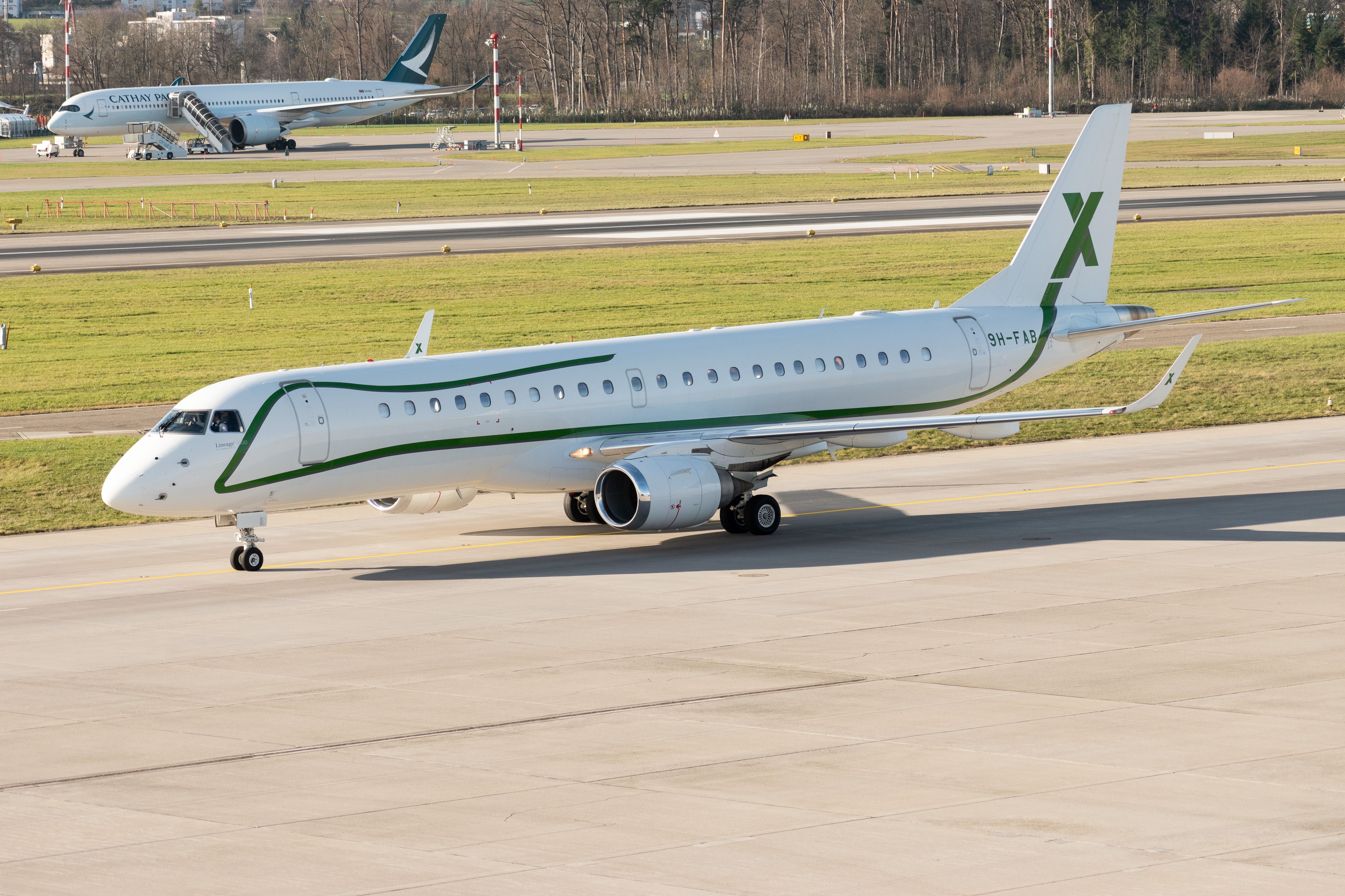 Embraer Lineage 1000 business aircraft is taxiing to the gate