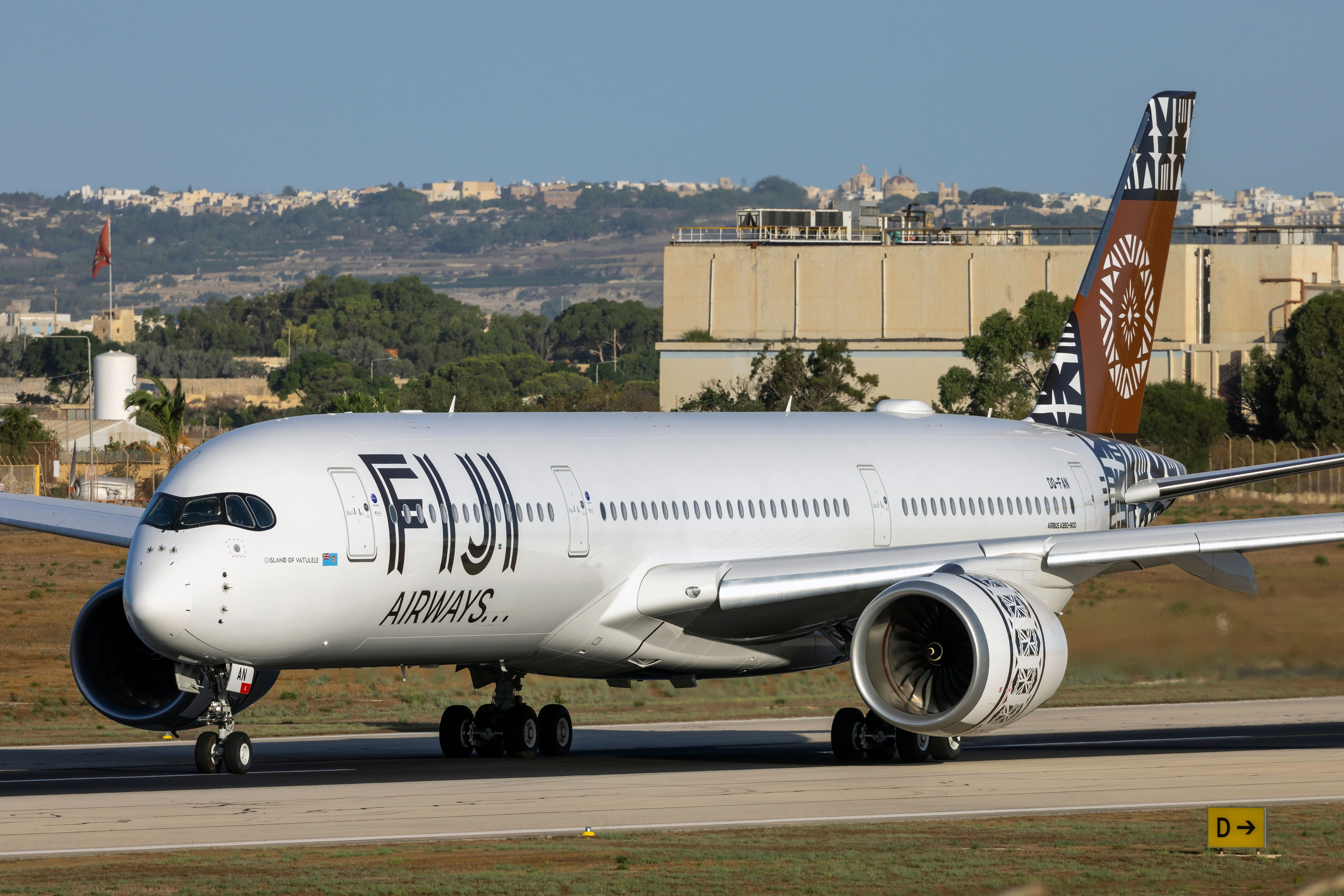 A Fiji Airways Airbus A350 on an airport apron.