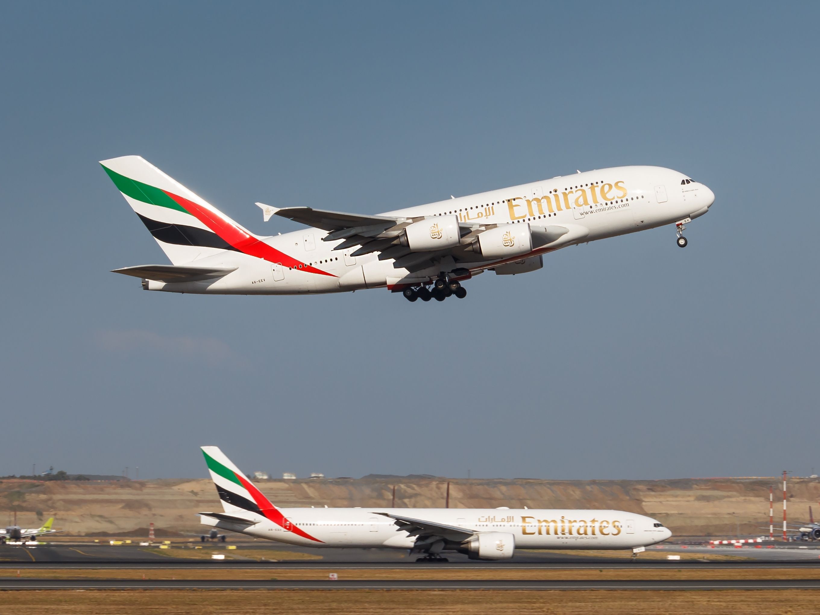 An Emirates Airbus A380 Taking Off Over An Emirates Boeing 777 In Istanbul.