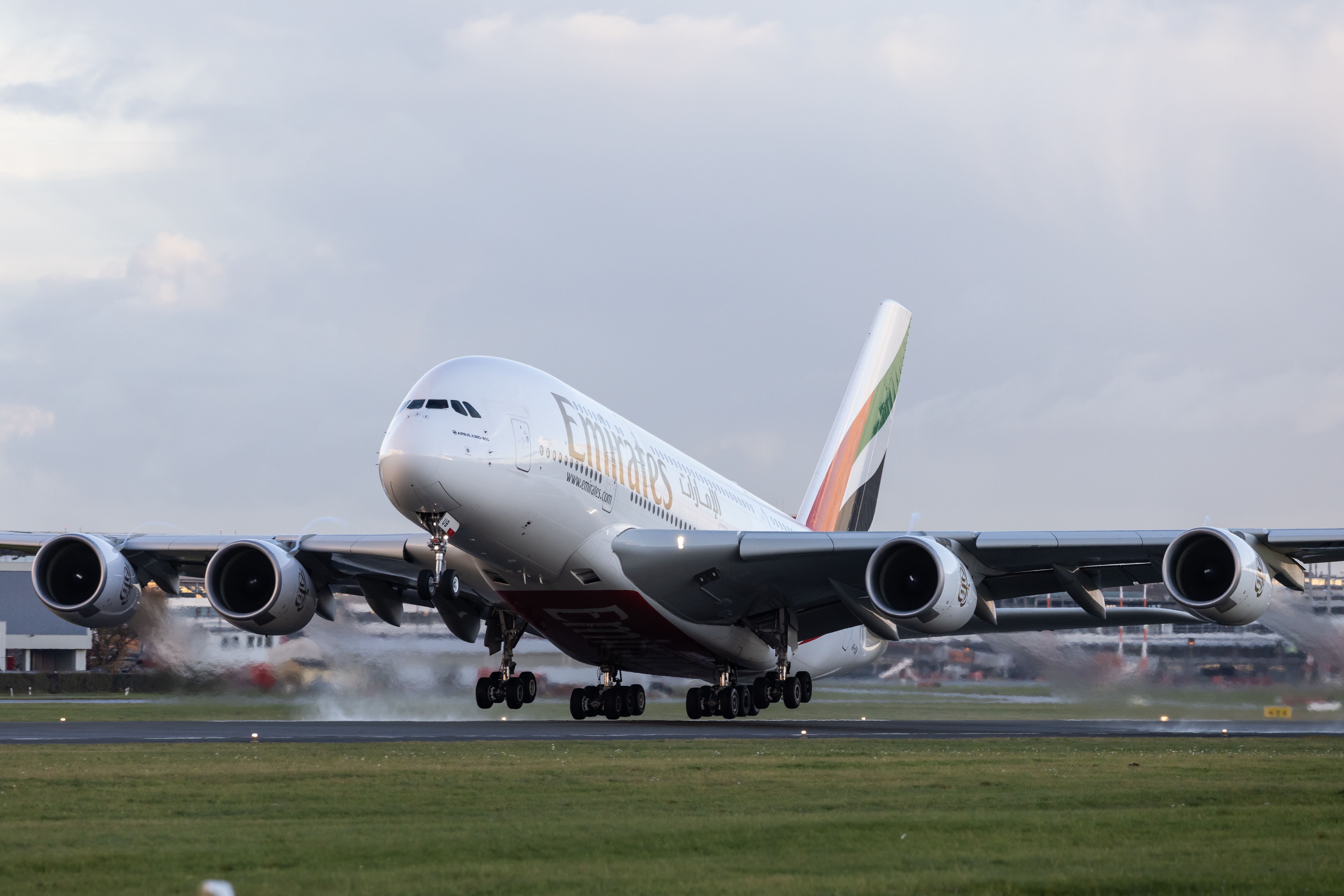 An Emirates Airbus A380 landing on a runway.