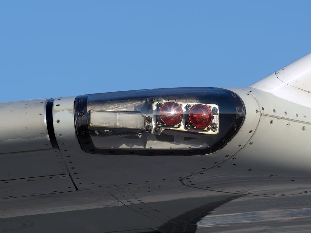 Two red lights on an aircraft wing.