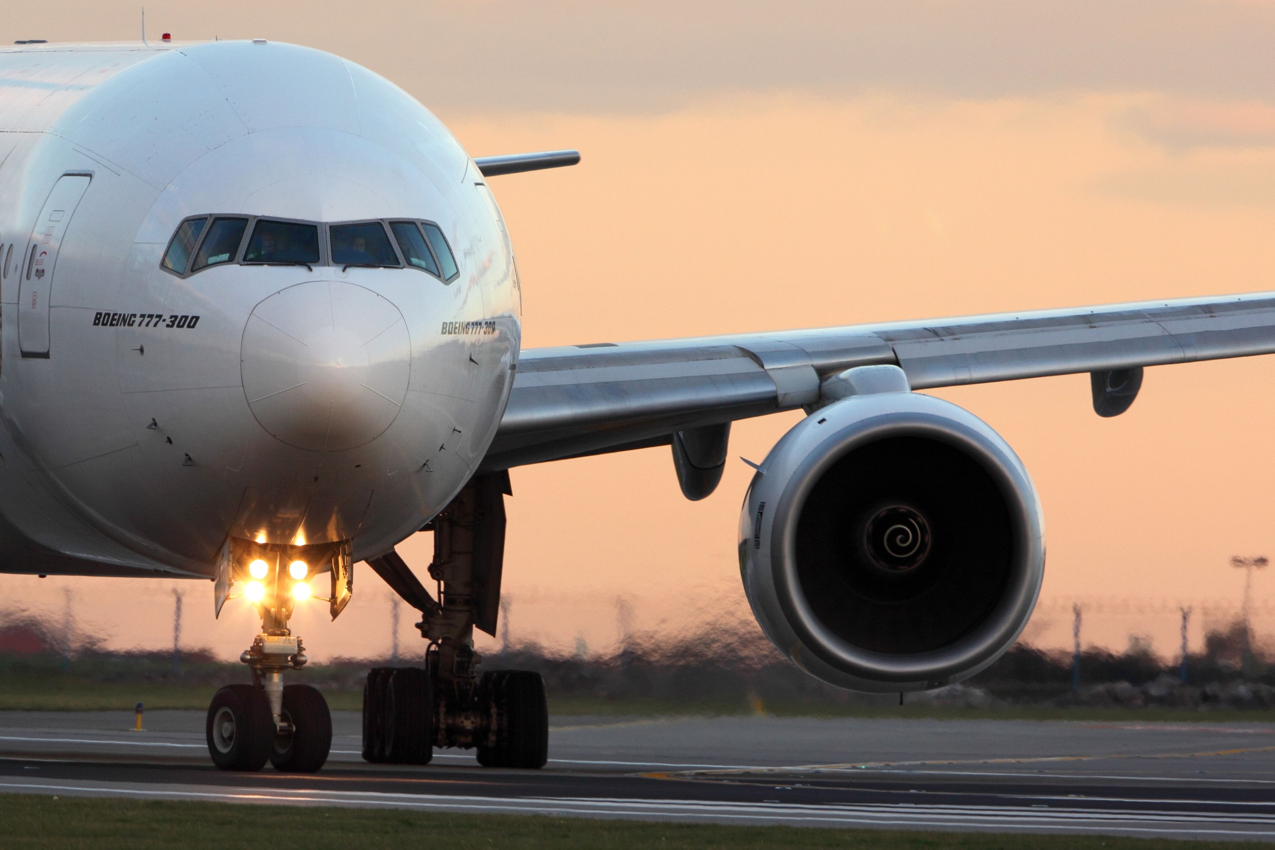 A closeup of a Boeing 777 at an airport.