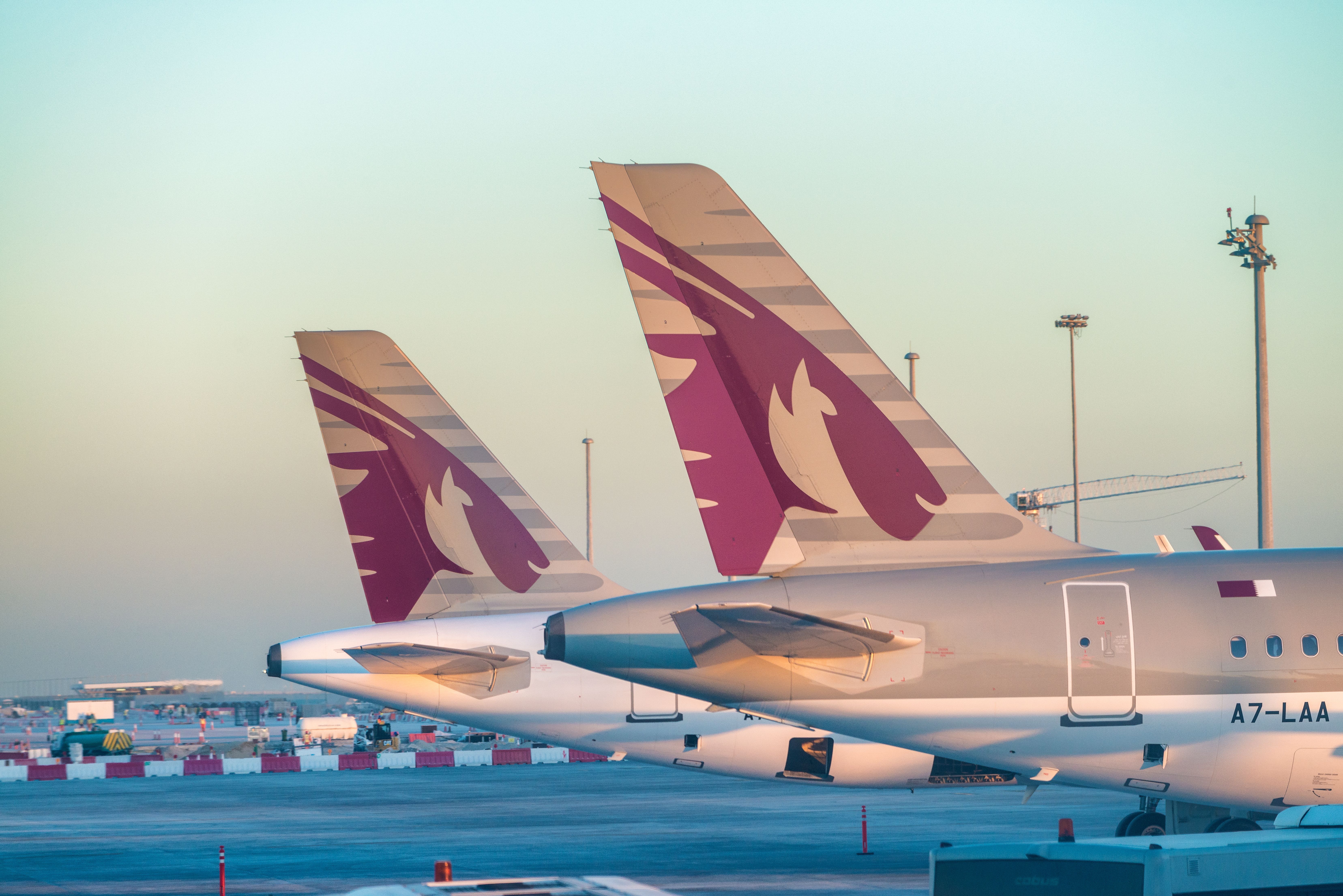 The tails of Two Qatar Airways aircraft at Doha Hammad Airport.