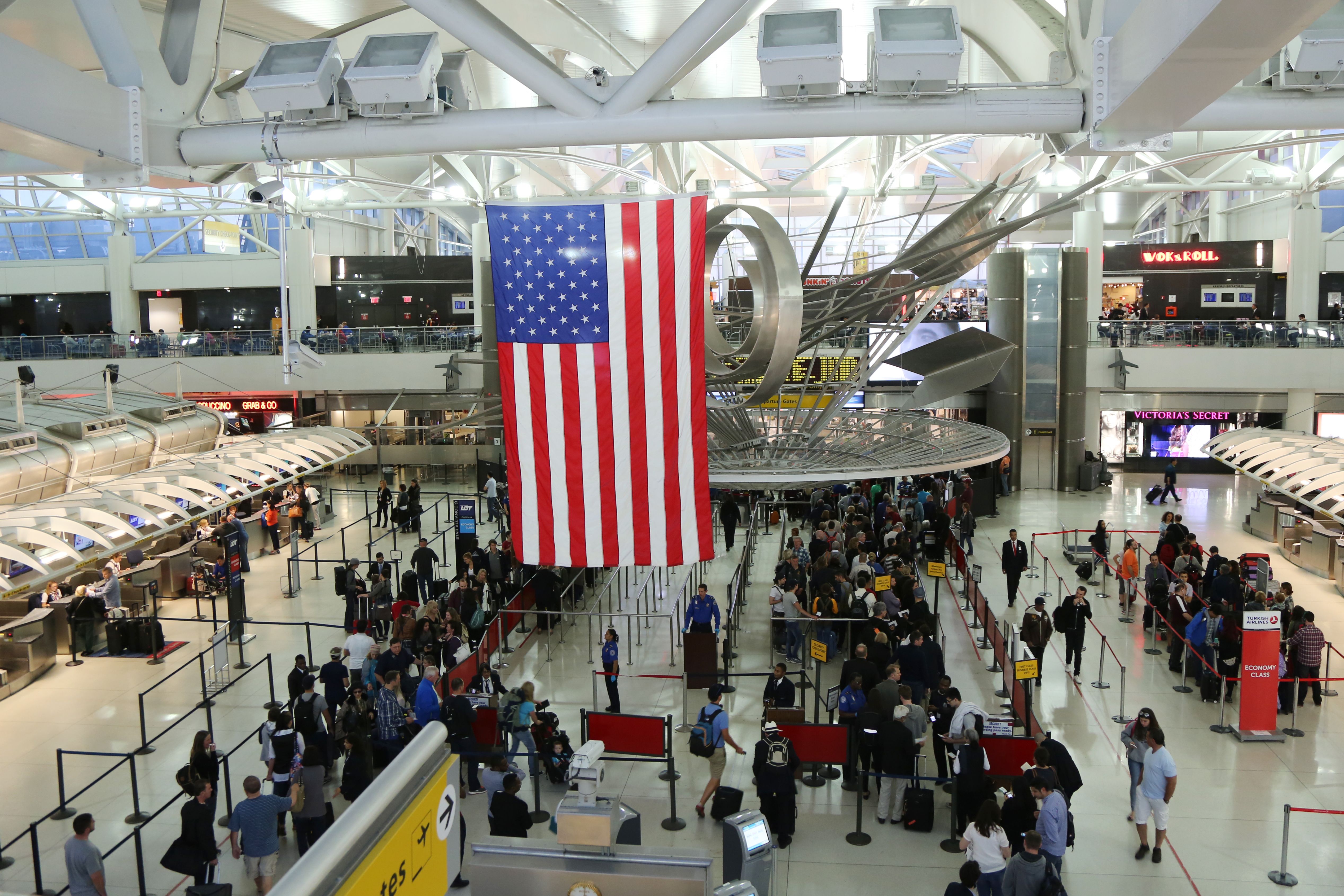 An aerial view of an American airport terminal building, overlooking the security area.