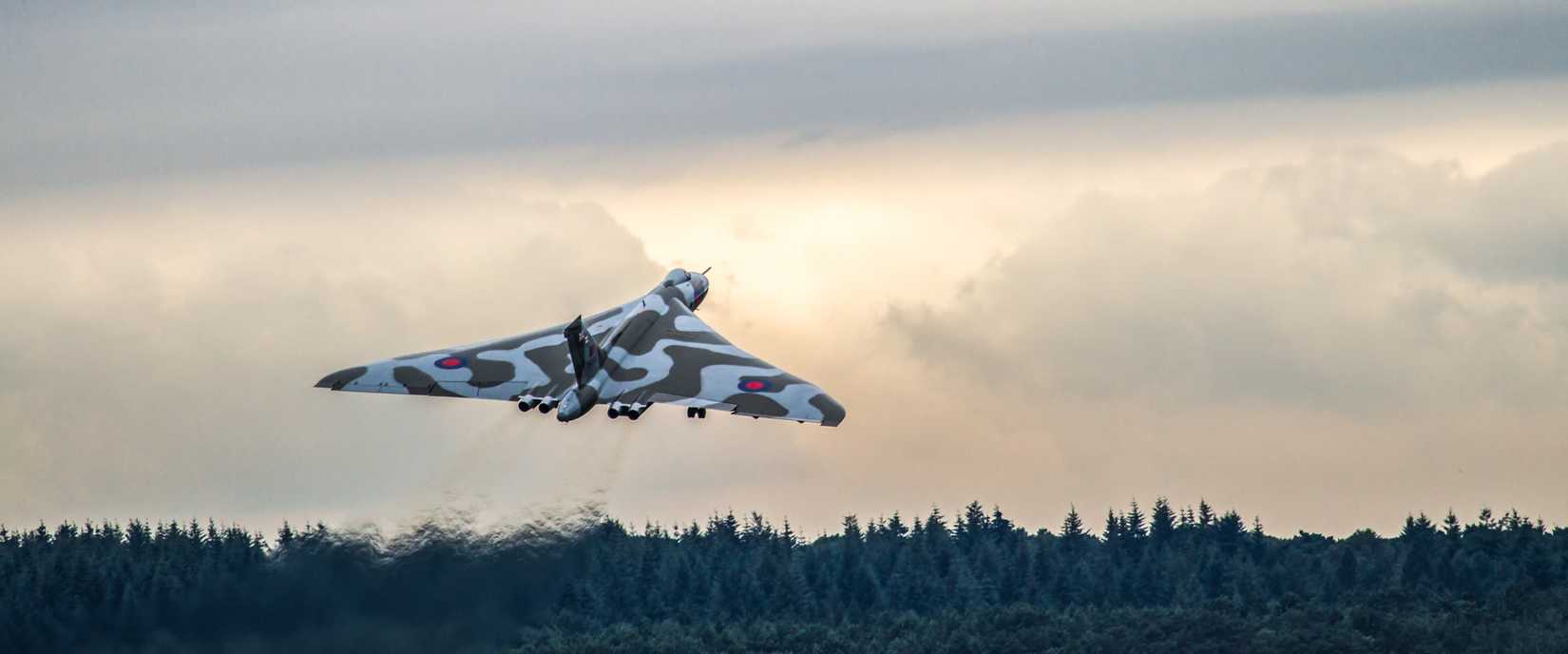 An Avro Vulcan taking off into the sunset.