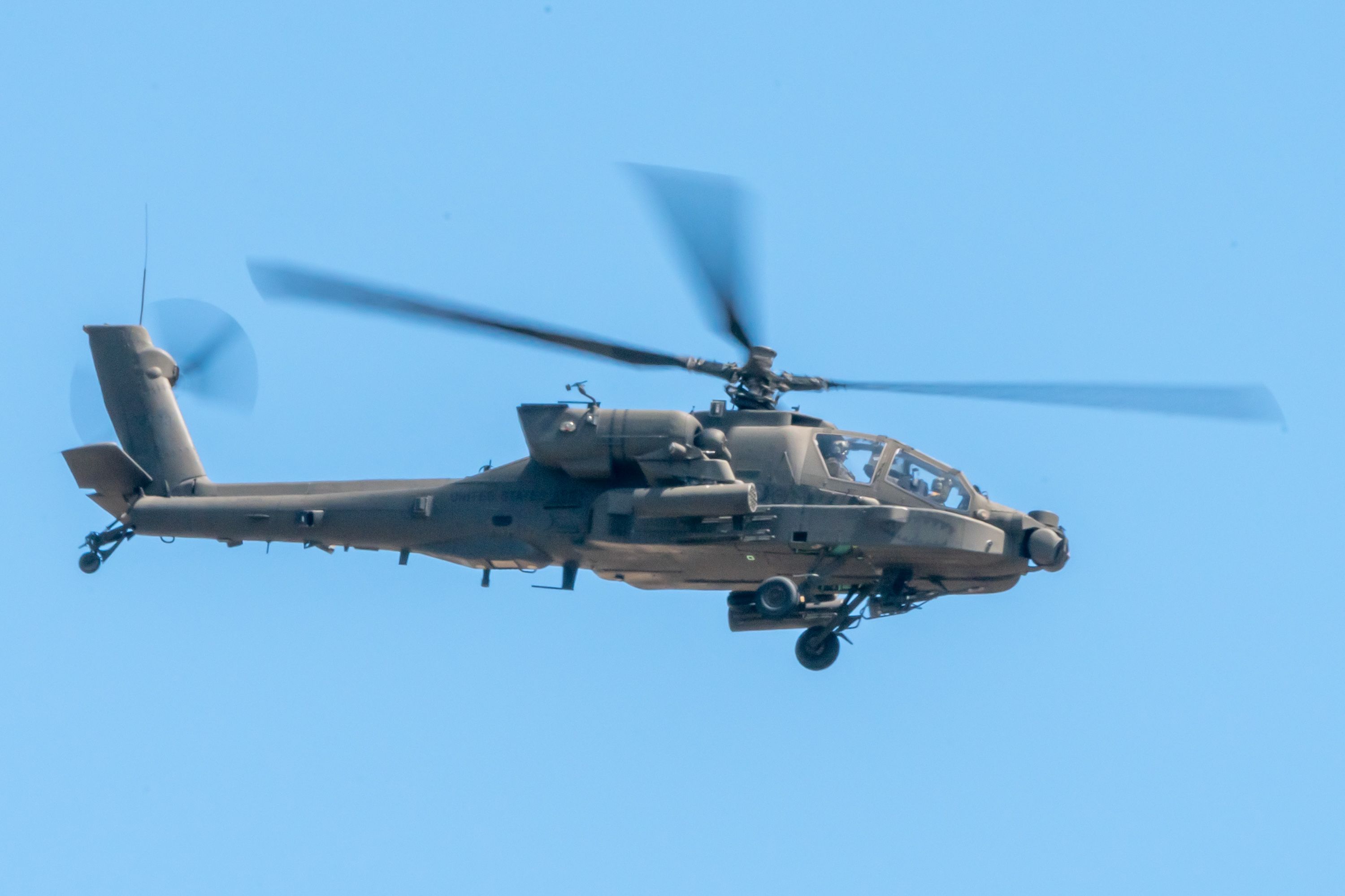 A Boeing AH-64 Apache flying in the sky.