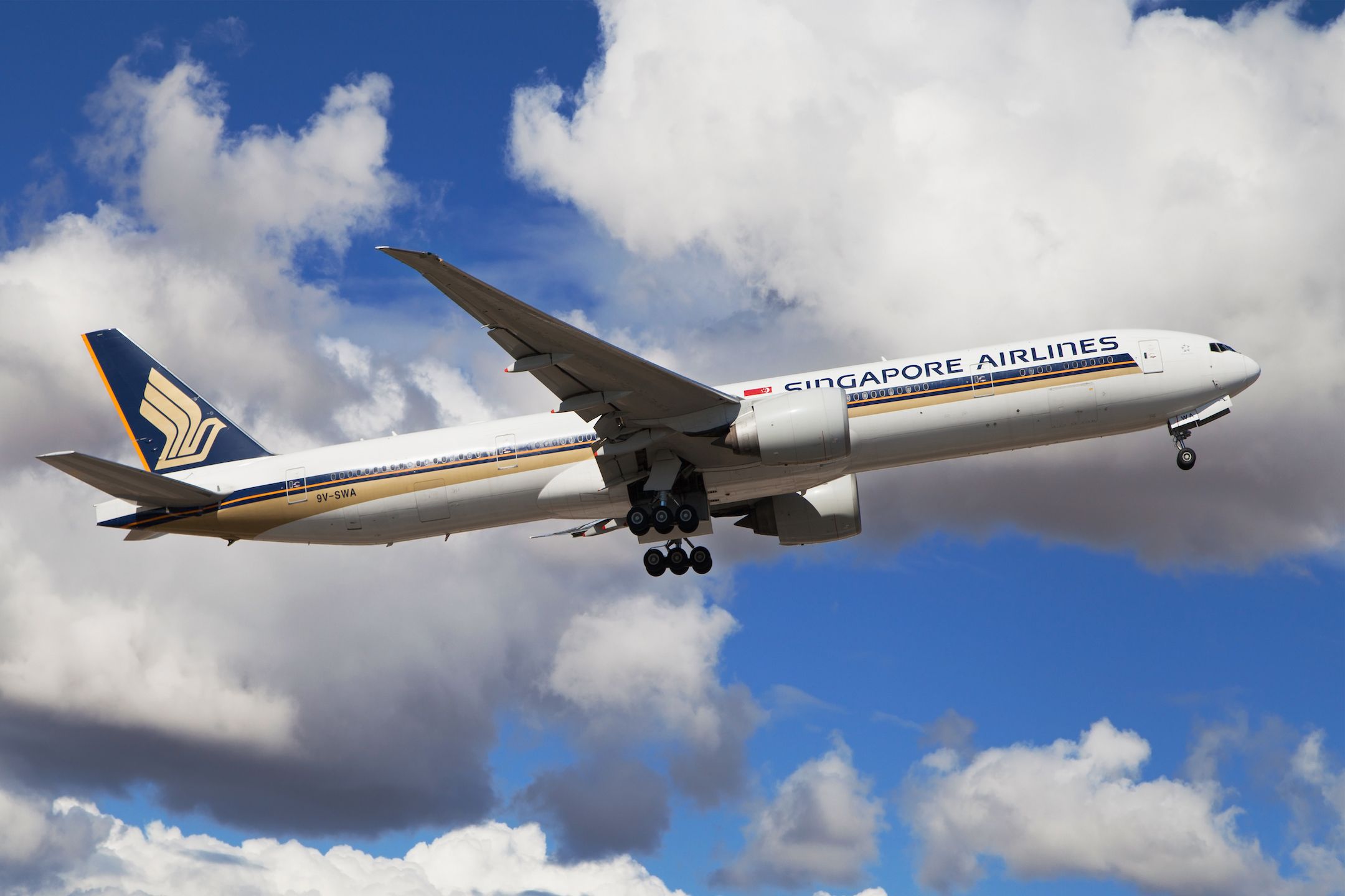 A Singapore Airlines Boeing 777-300ER flying in the sky.