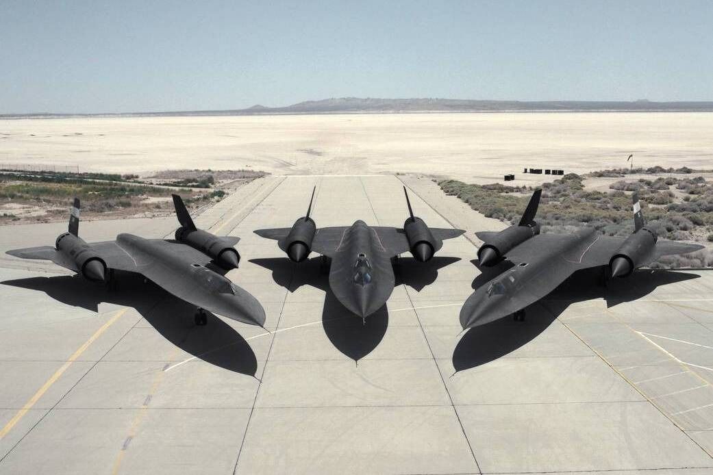 Three SR-71 Blackbird Aircraft parked at an airfield.