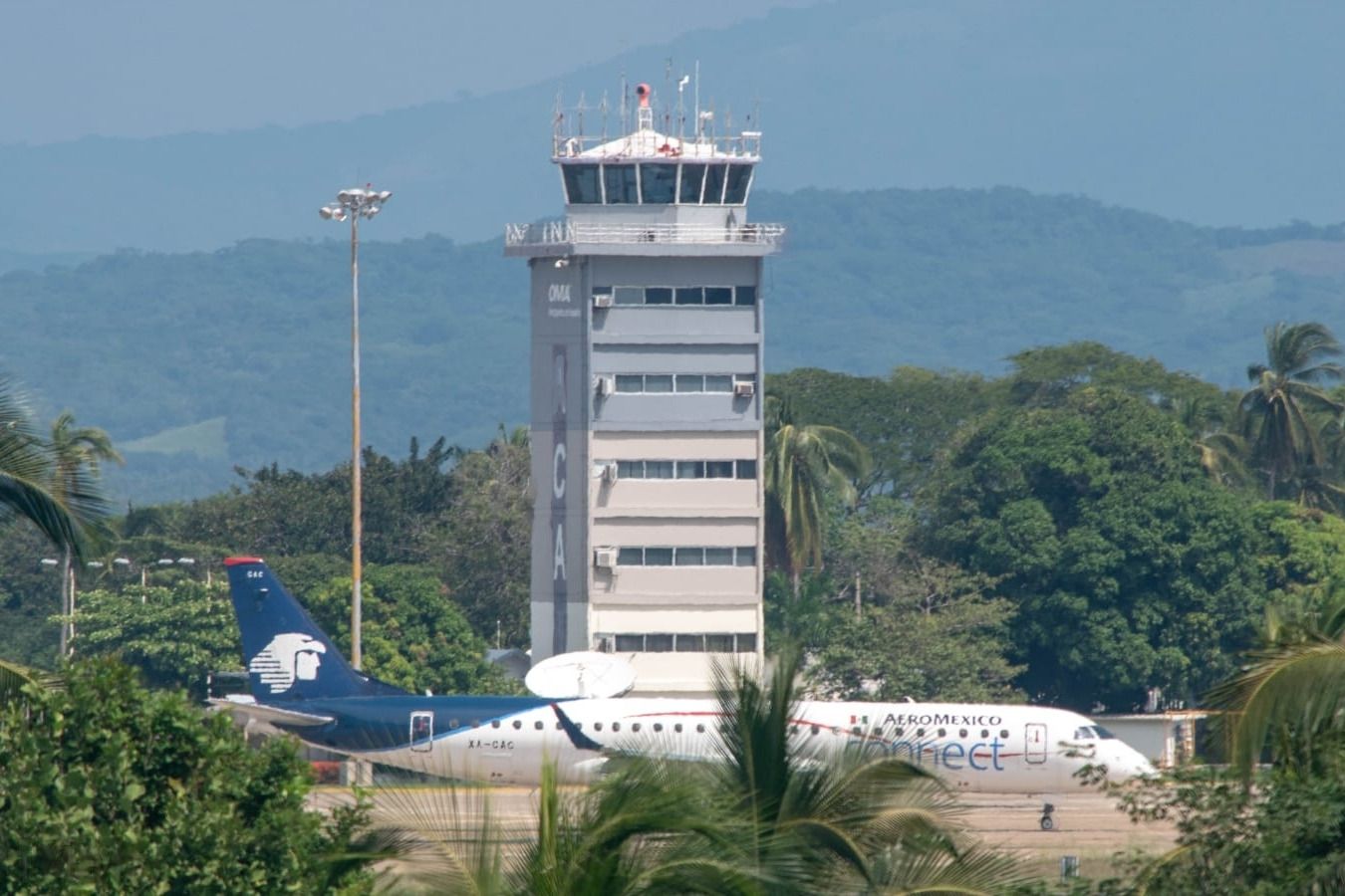 A view of Acapulco International Airport and an Aeromexico aircraft in the front. 