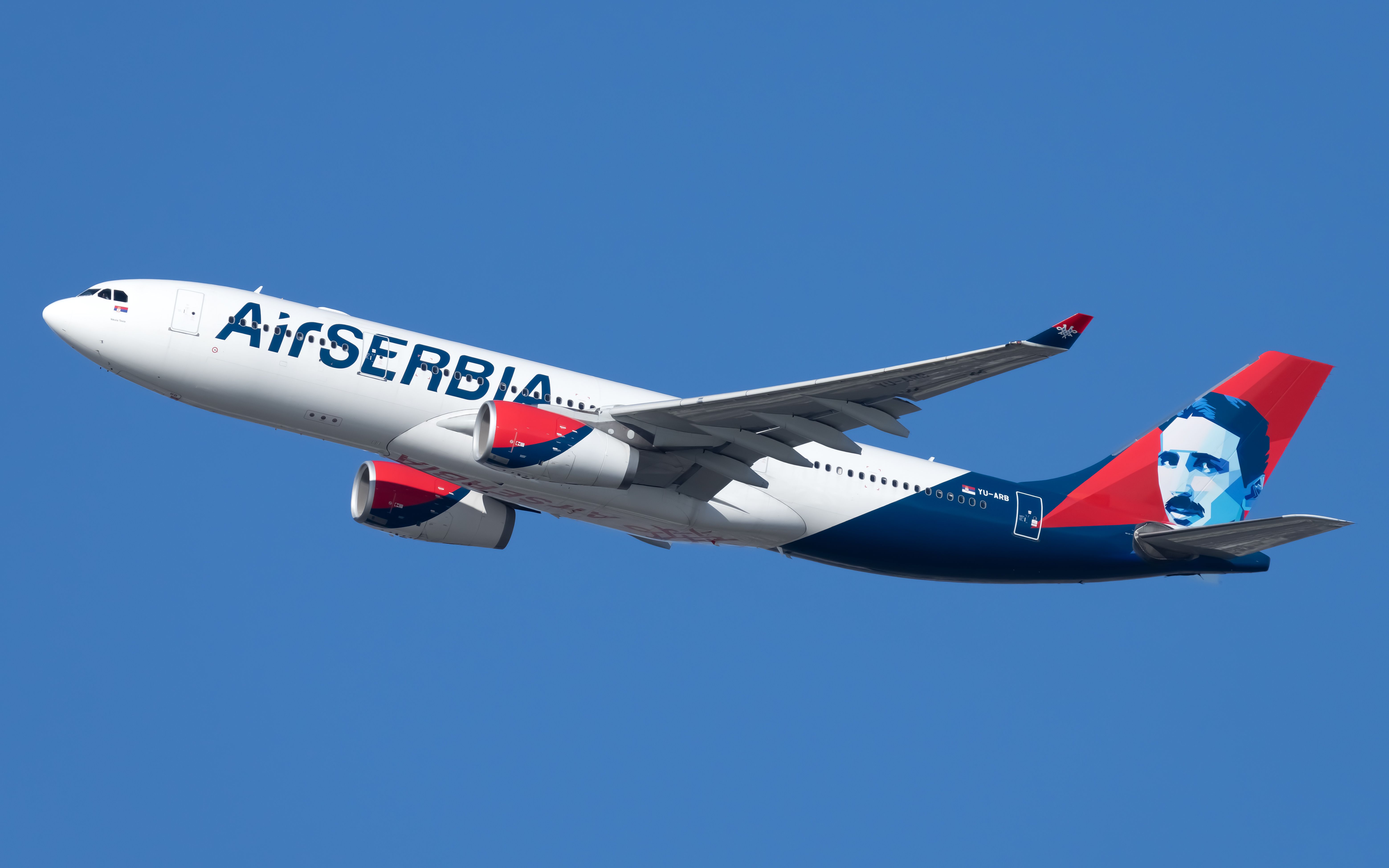 An Air Serbia Airbus A330-200 flying in the sky.