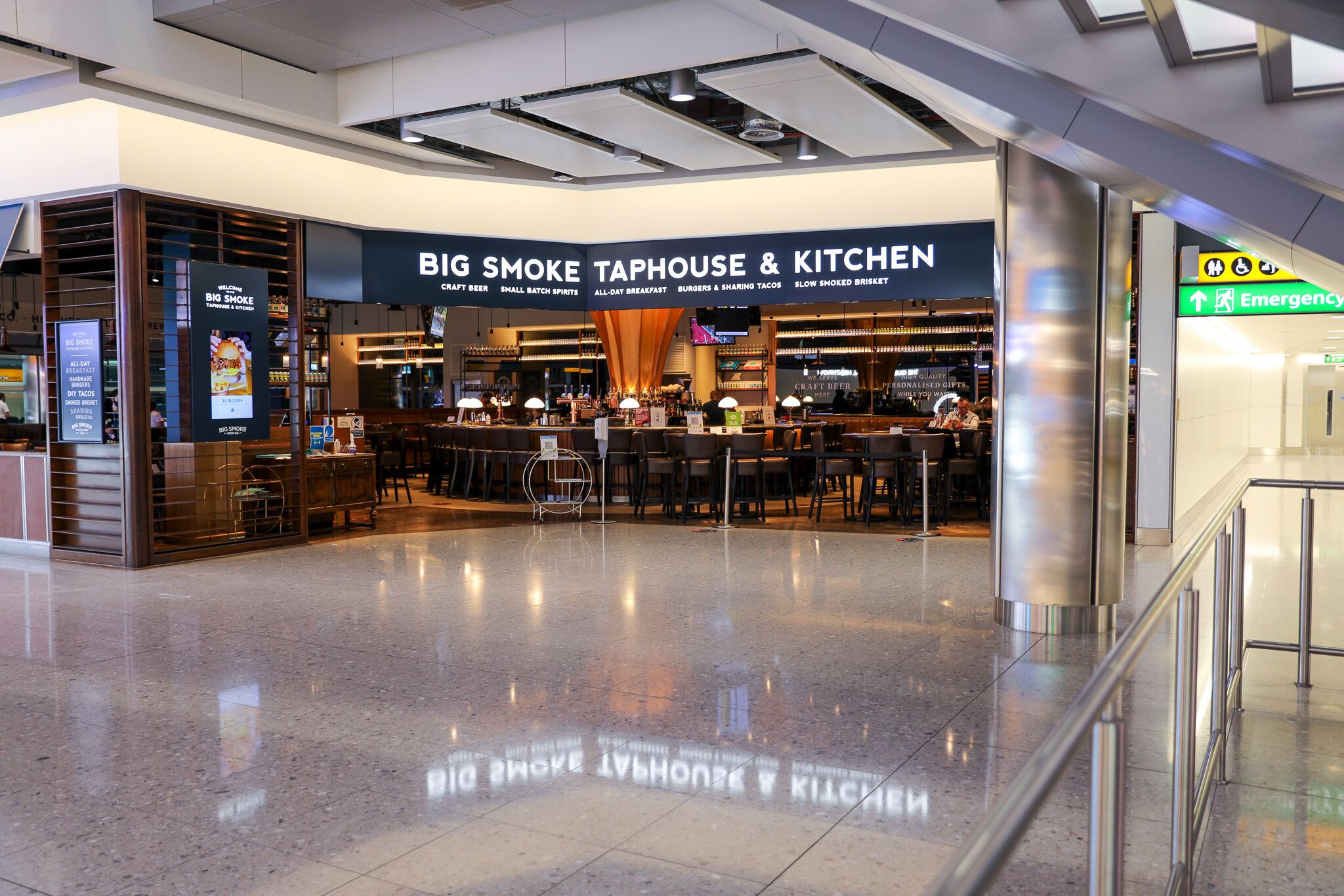 A restaurant called Big Smoke Taphouse and Kitchen inside an airport terminal.