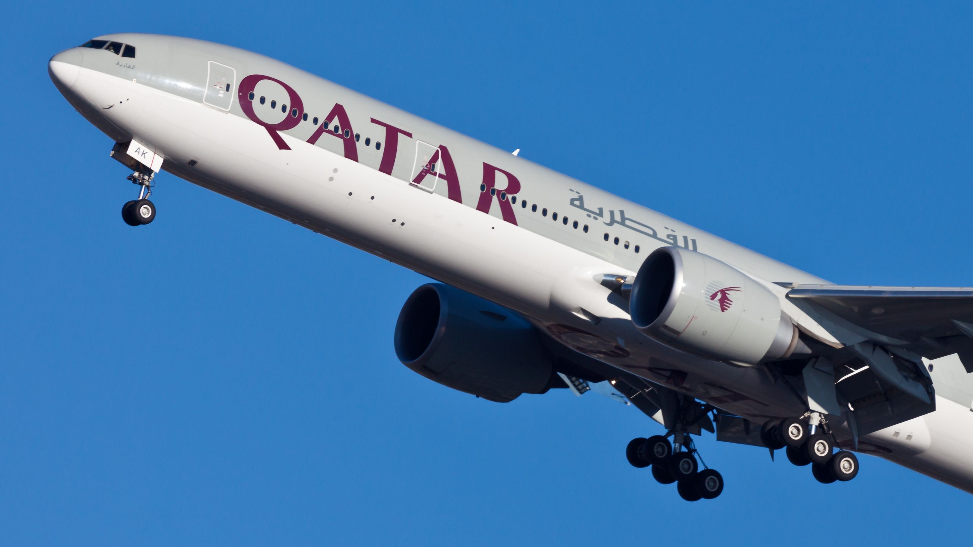 A Qatar Airways Boeing 777 flying in the sky.