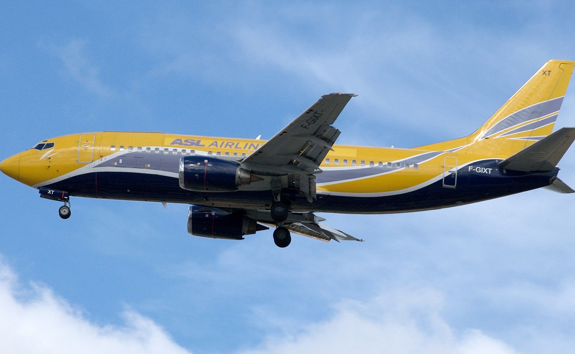 An ASL Airlines Boeing 737 flying in the sky.