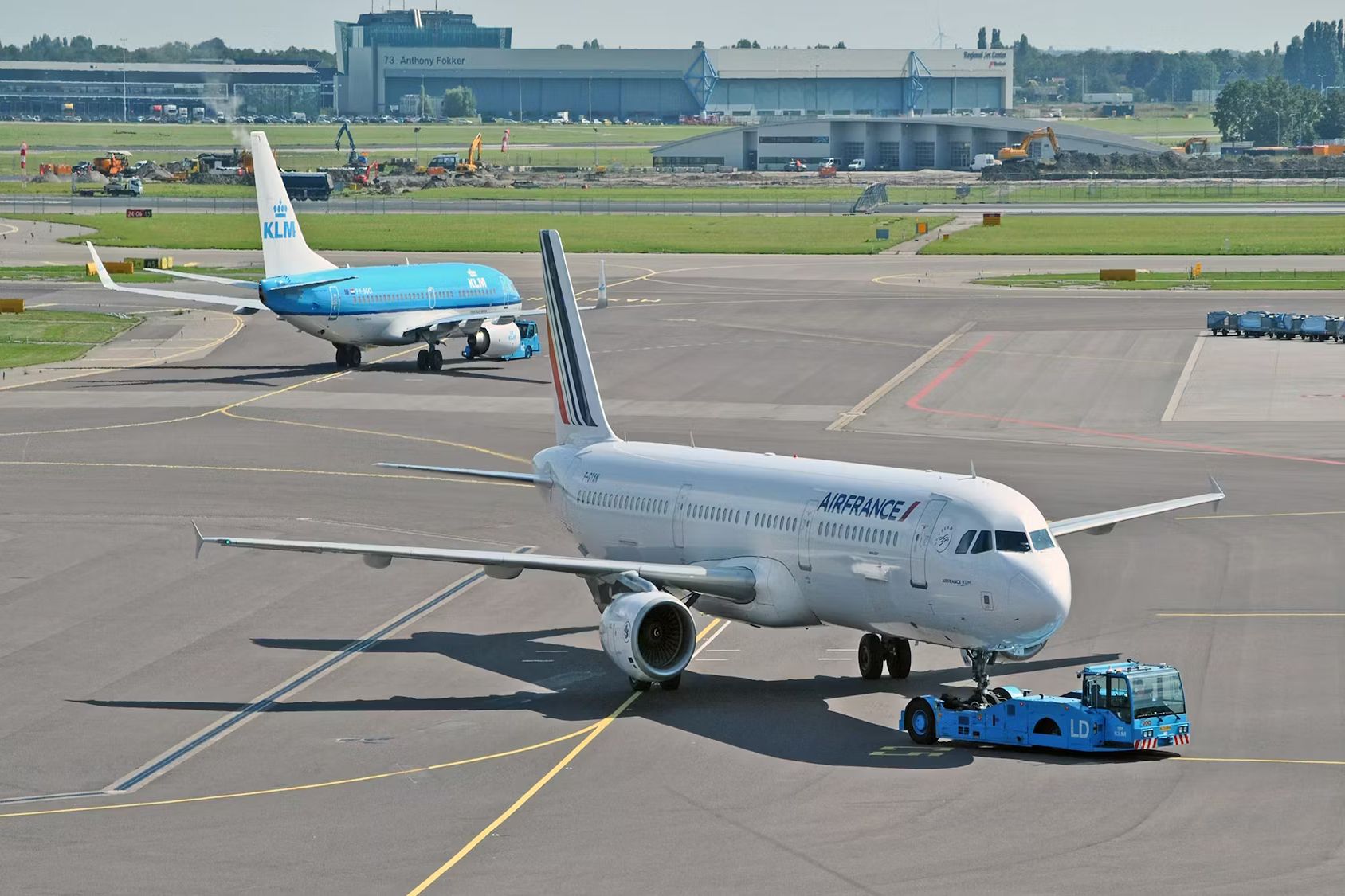 KLM and Air France aircraft being pushed back on the apron at Amsterdam Schiphol Airport.