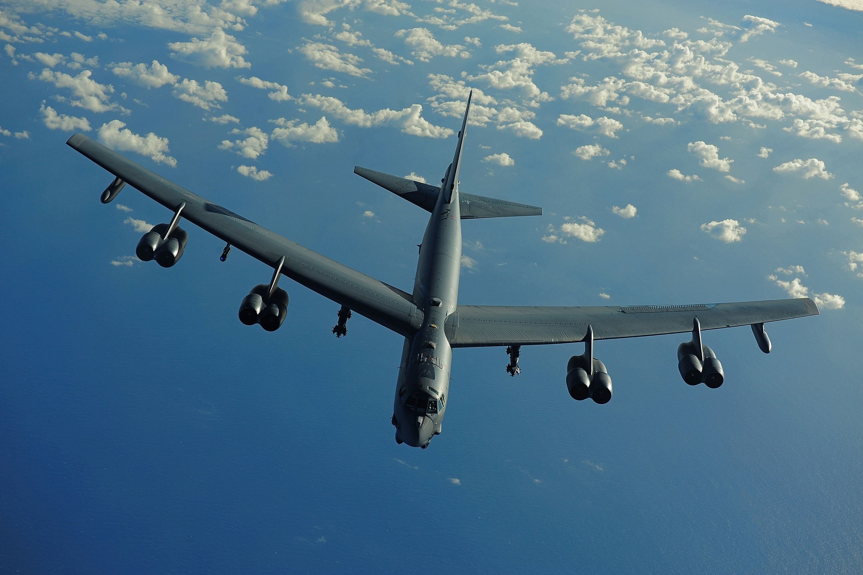 A Boeing B-52 flying over water.