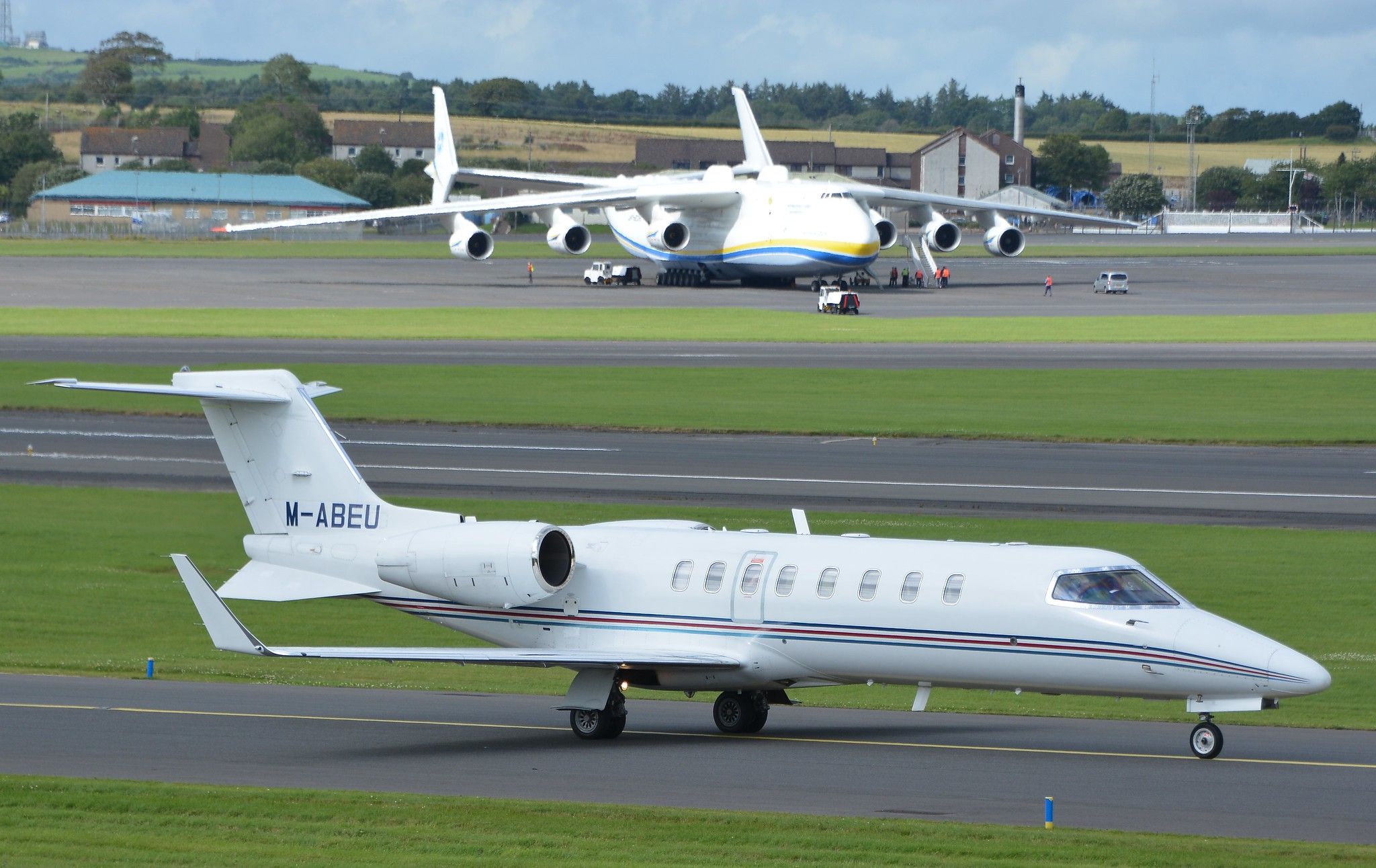 Ryanair Learjet 45 Taxiing Past Antonov An-225 At Prestwick Airport