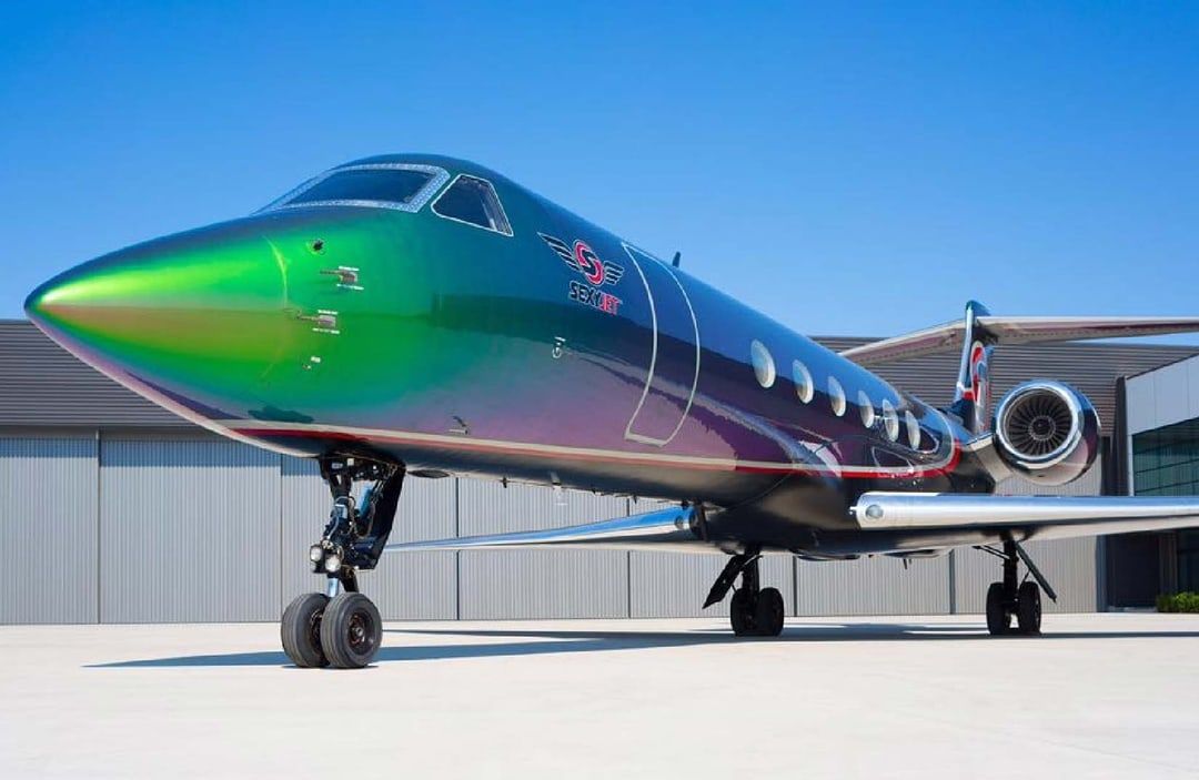 The Gulfstream GV SEXYJet parked outside of a hangar.