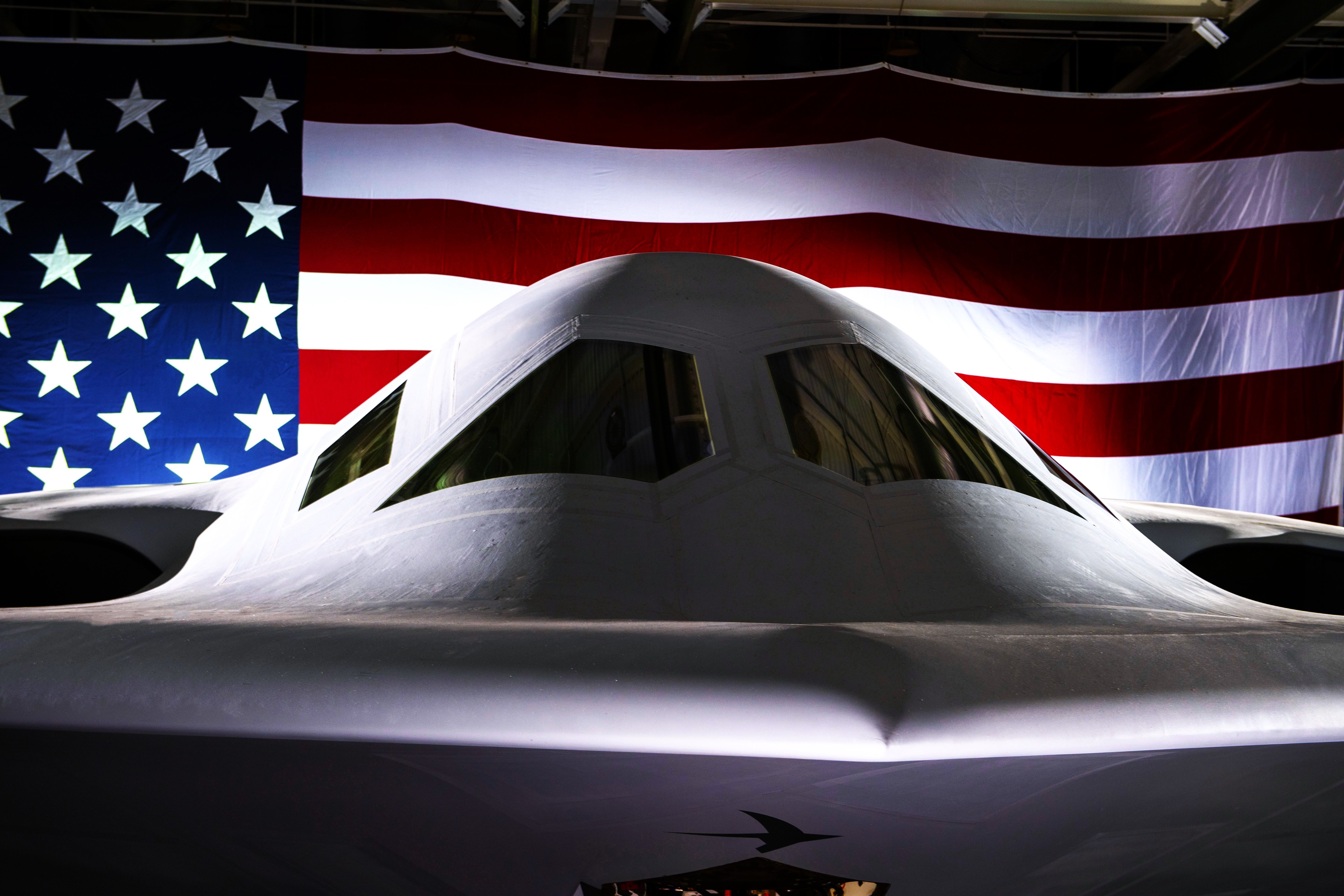 A Closeup of a B-21 Raider in front of an American Flag.