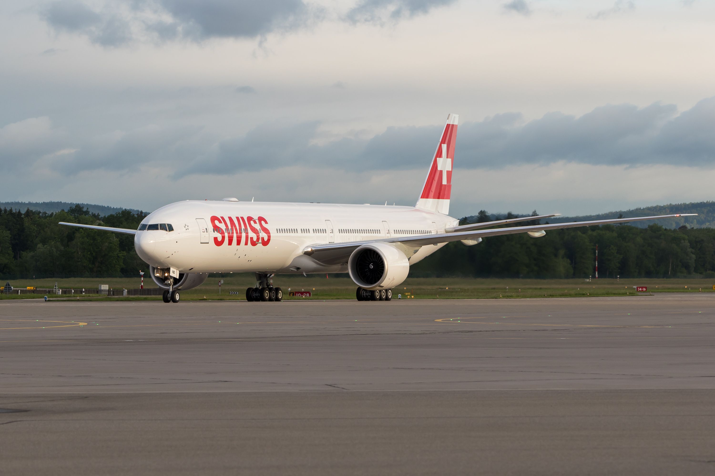 A SWISS Boeing 777-300ER on an airport apron.