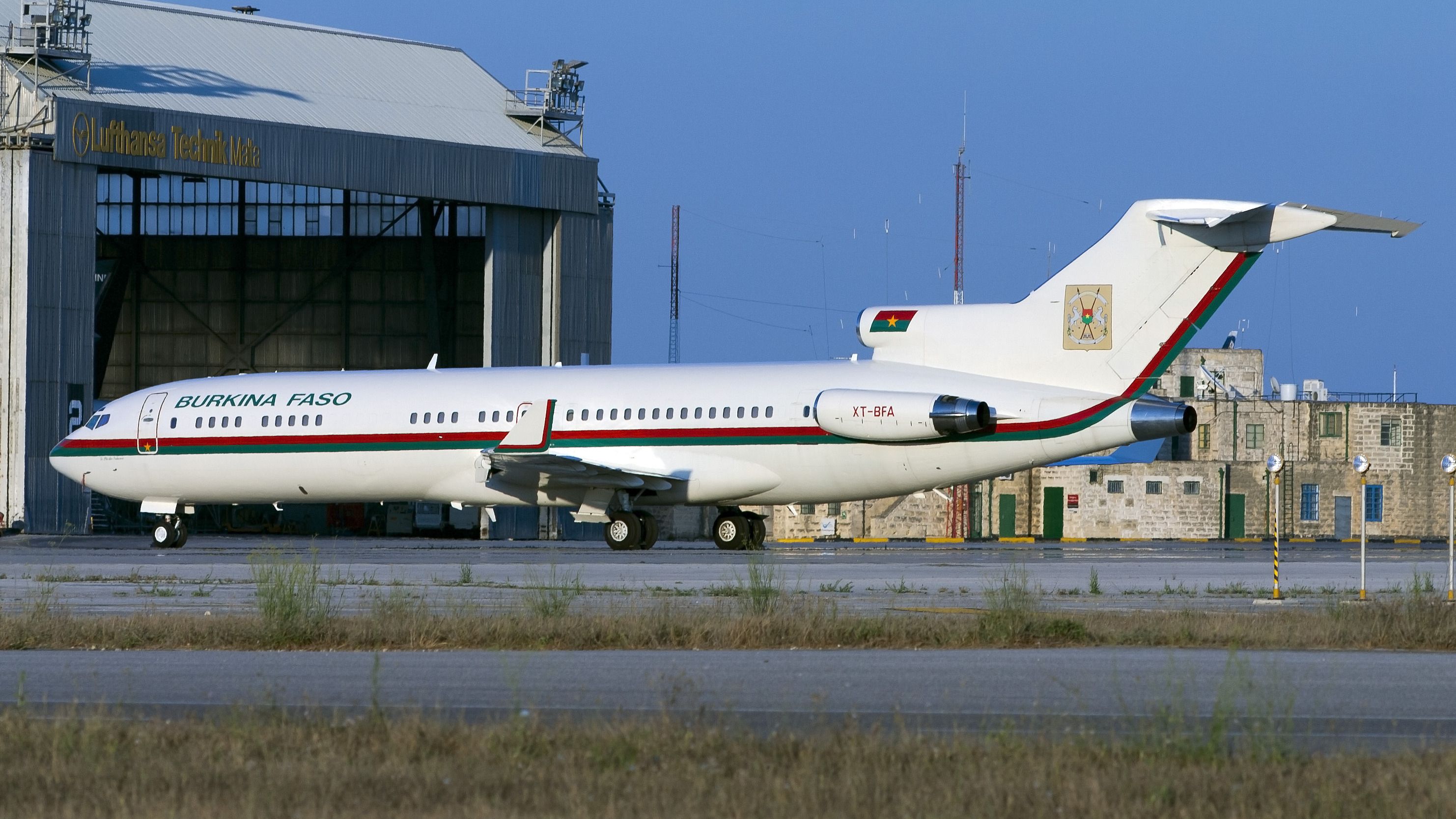 A Burkina Faso Government Boeing 727 parked on an airport apron.