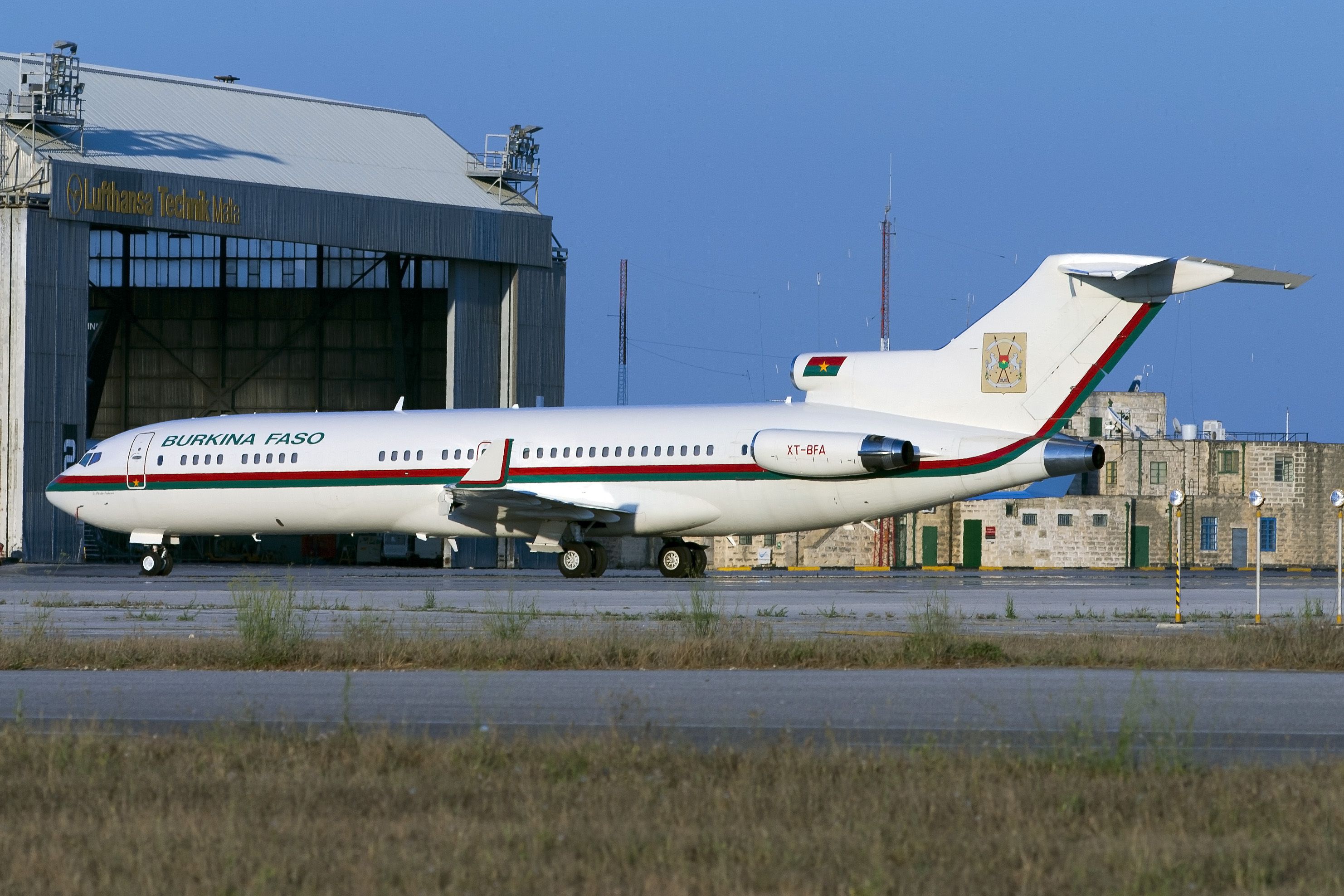 A Burkina Faso Government Boeing 727 parked on an airport apron.