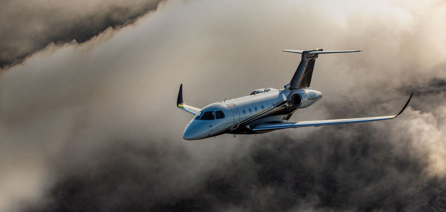 A Business Jet flying above the clouds.