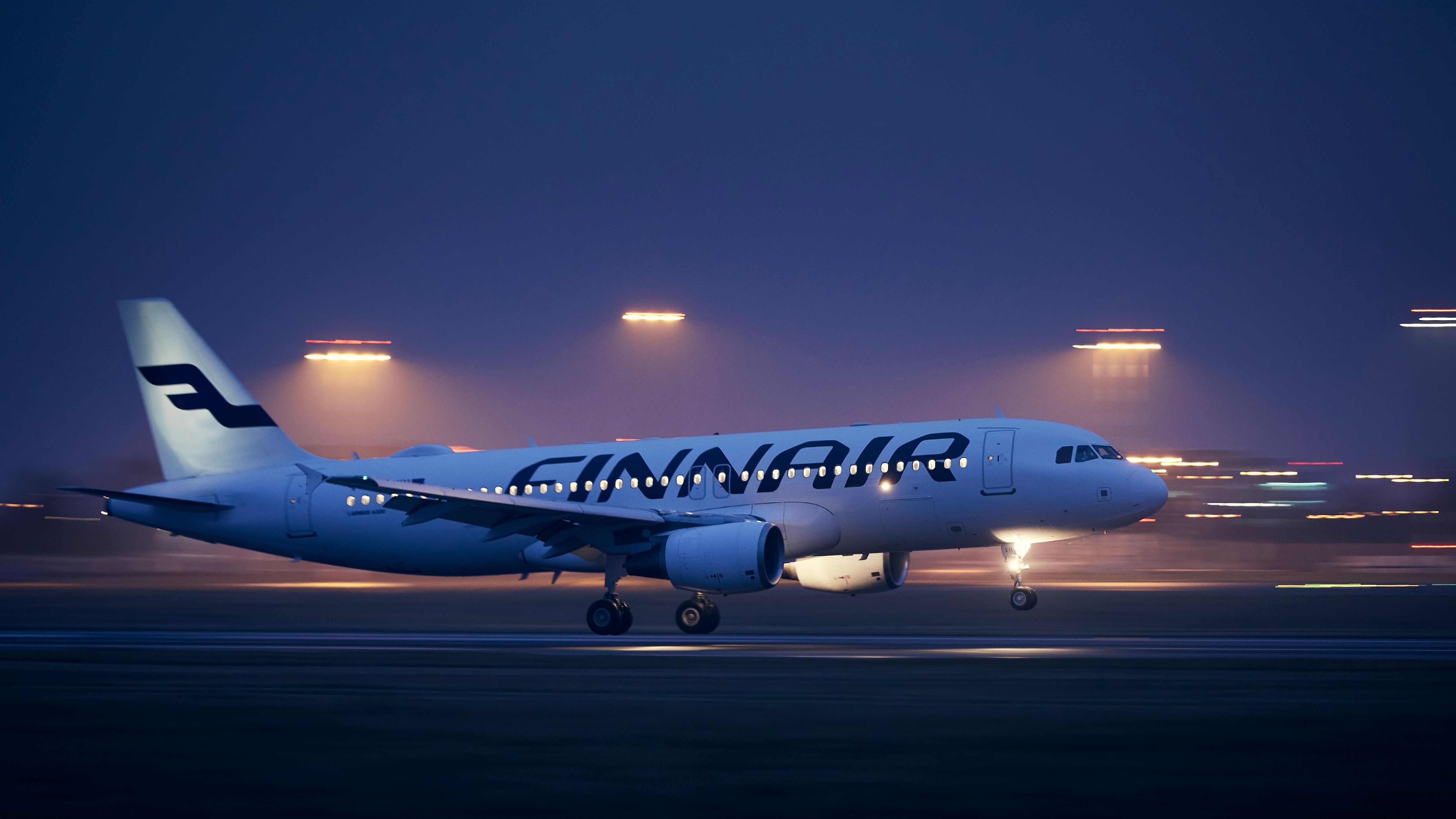 A Finnair Airbus A320 landing in Prague during the night 