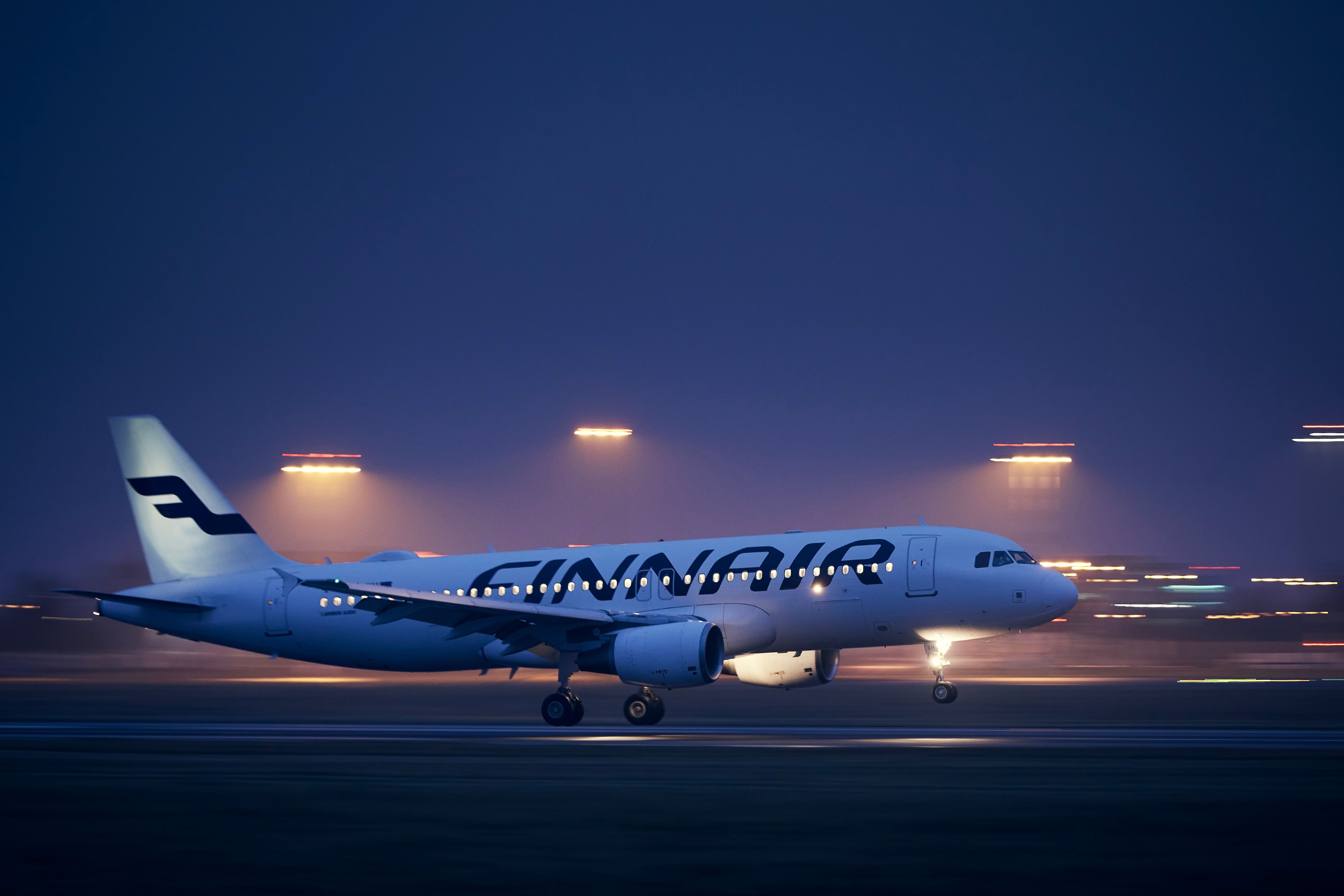 A Finnair Airbus A320 landing in Prague during the night 