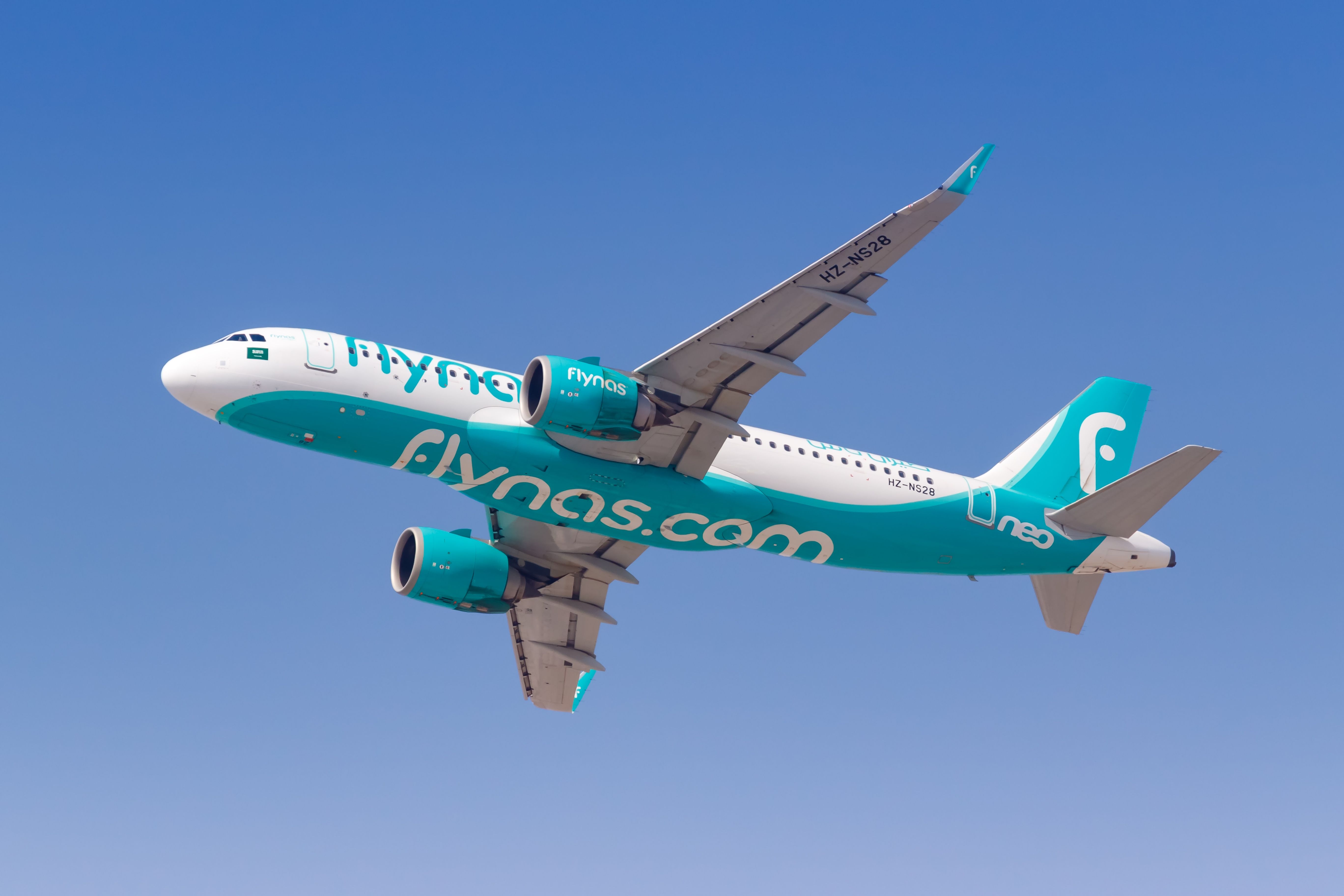A Flynas Airbus A320neo flying in the sky.