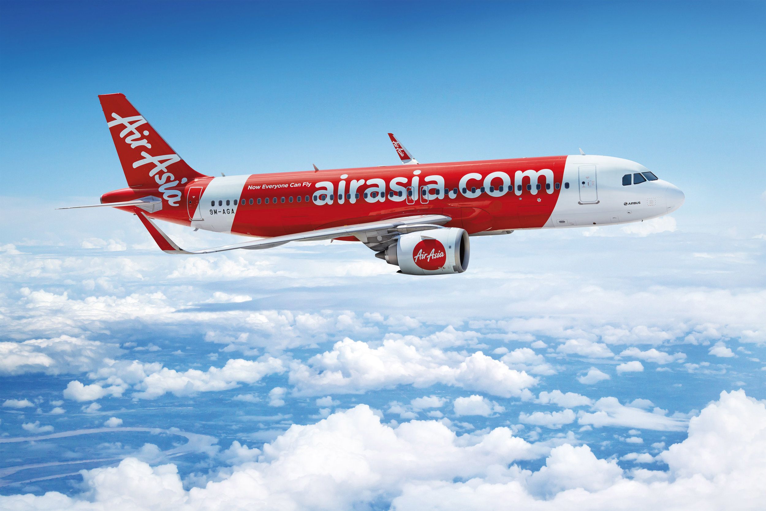 An AirAsia Airbus A320 flying in the sky.