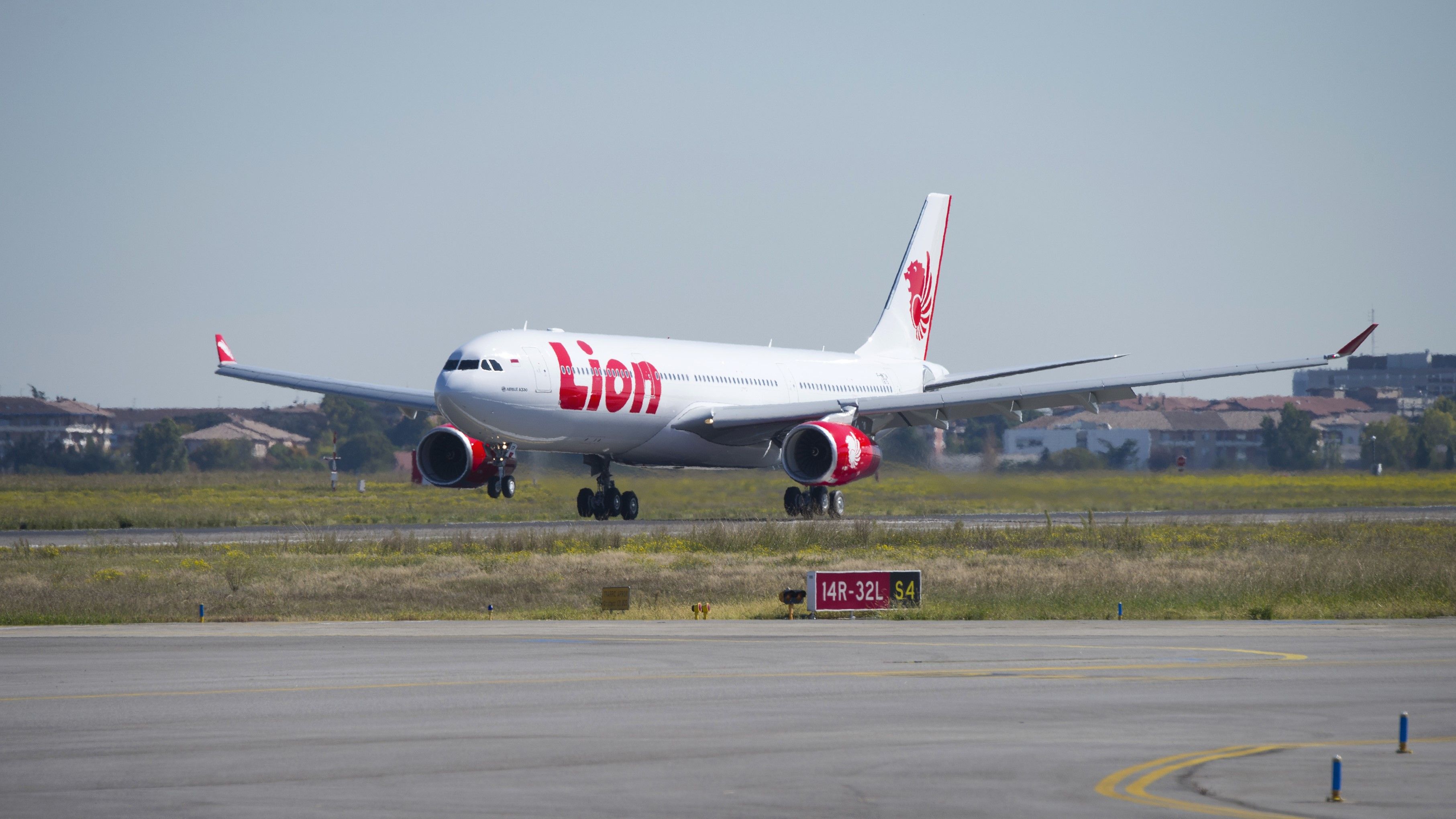 A Lion Air Airbus A330-300 as it lands on a runway.