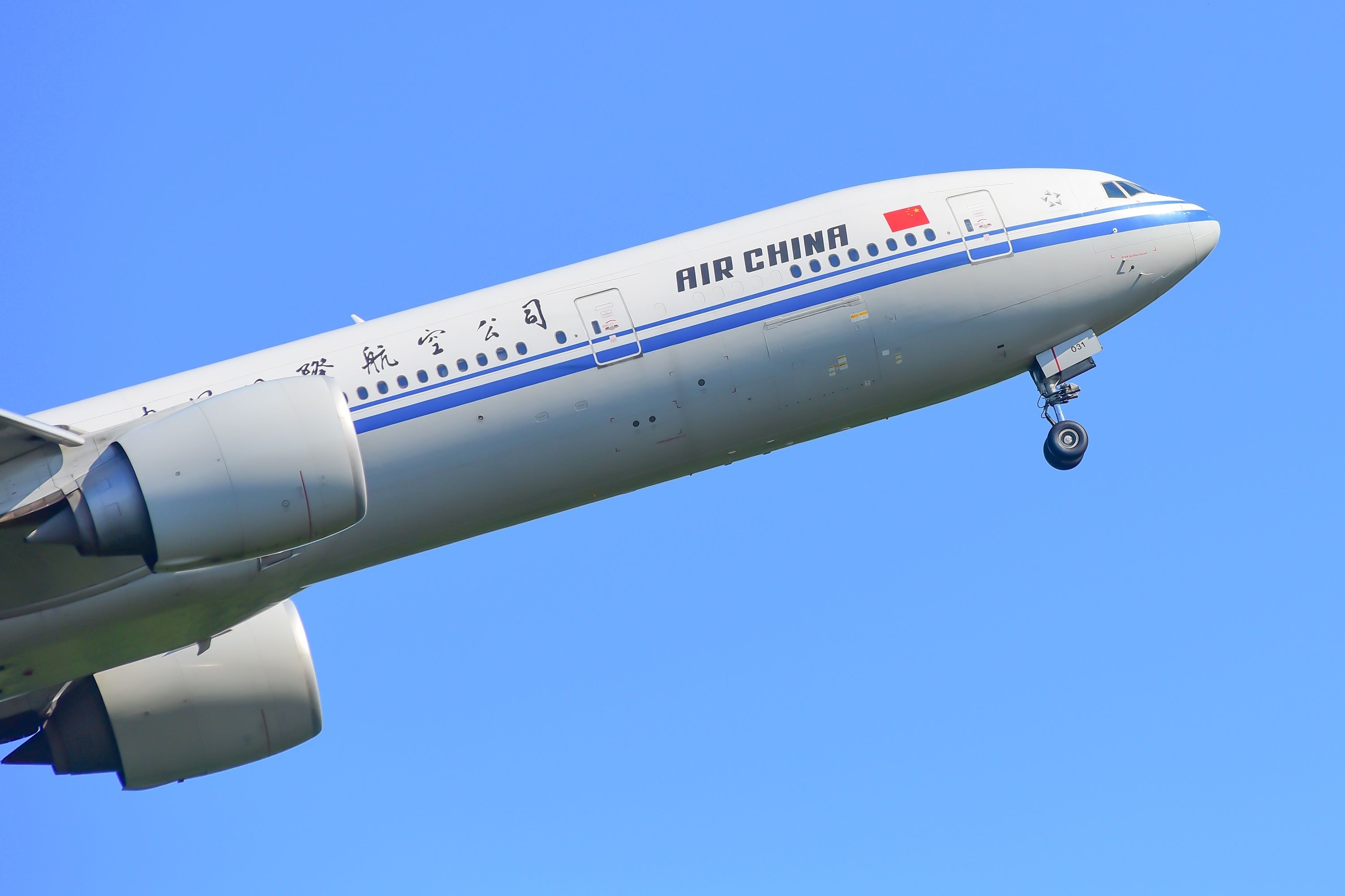 An Air China Boeing 777-300ER flying in the sky.
