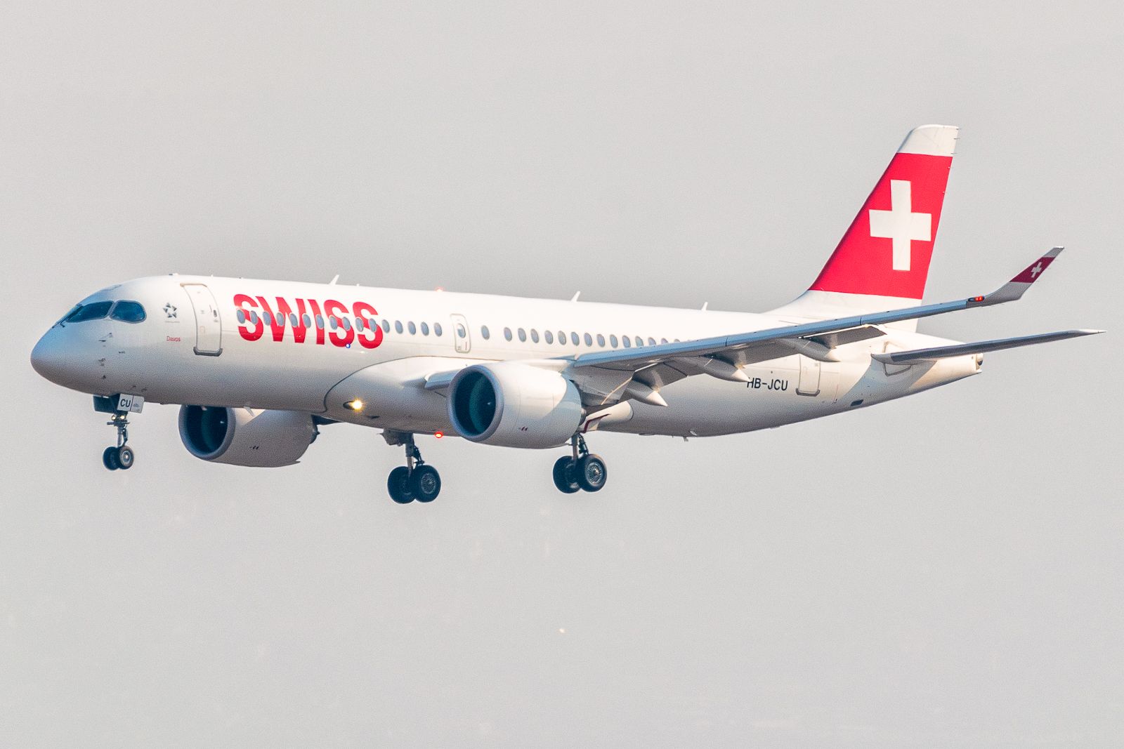 A SWISS Airbus A220 flying in the sky.