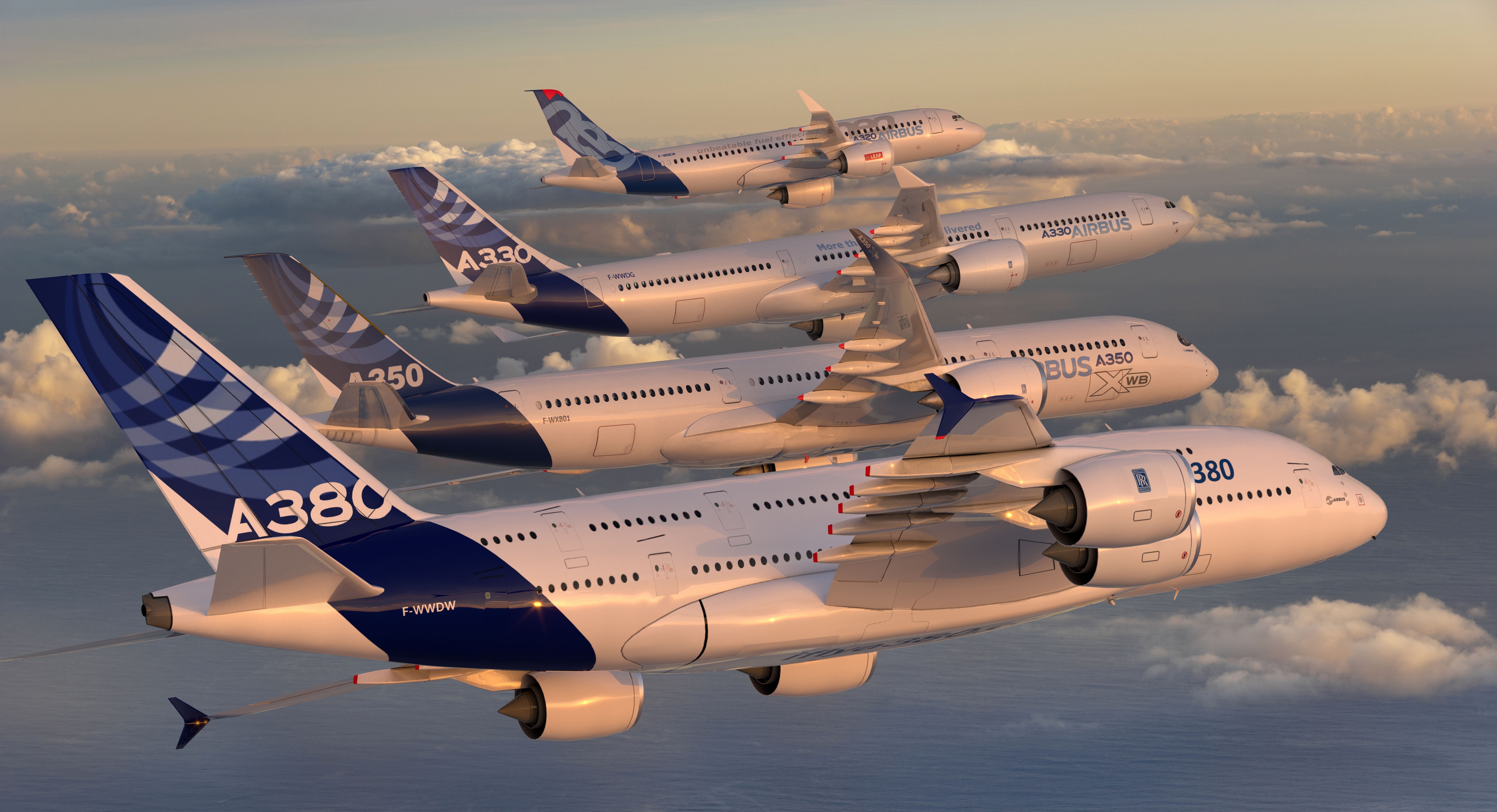 An Airbus A380, A350, A330, and A320 flying together above the clouds.