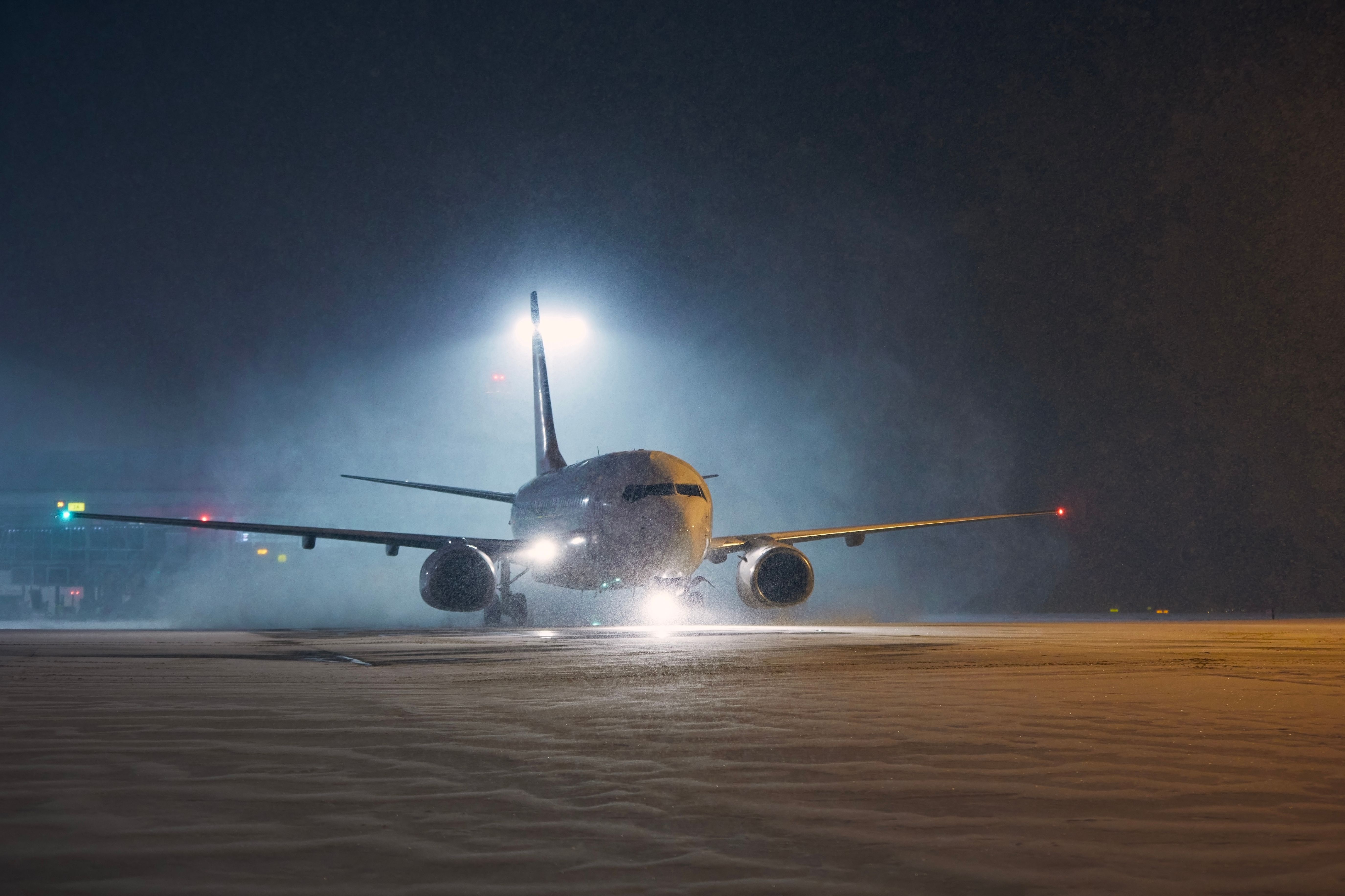 An aircraft in a runway during a snow storm 