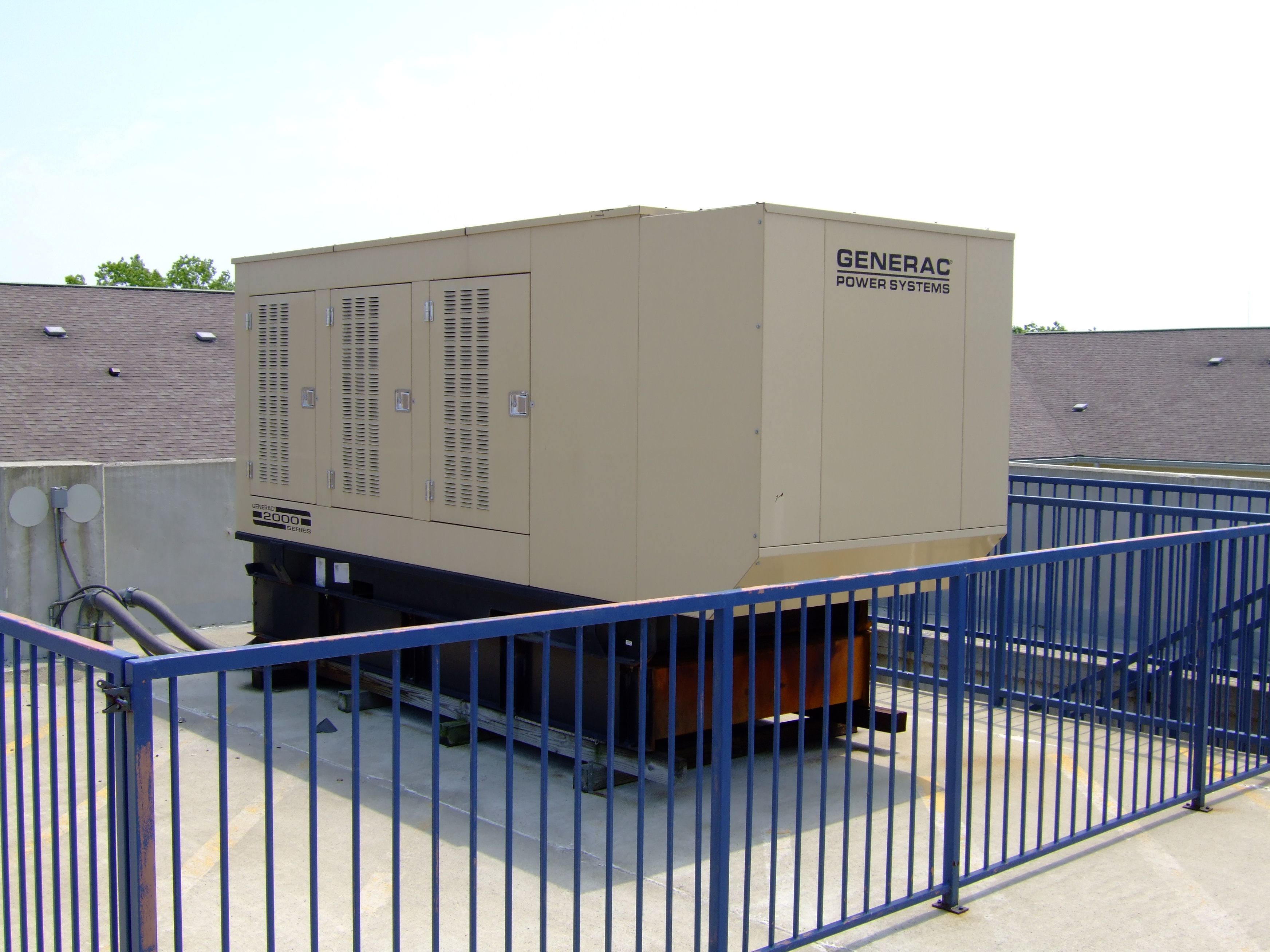 A large Generac power generator on top of a building.