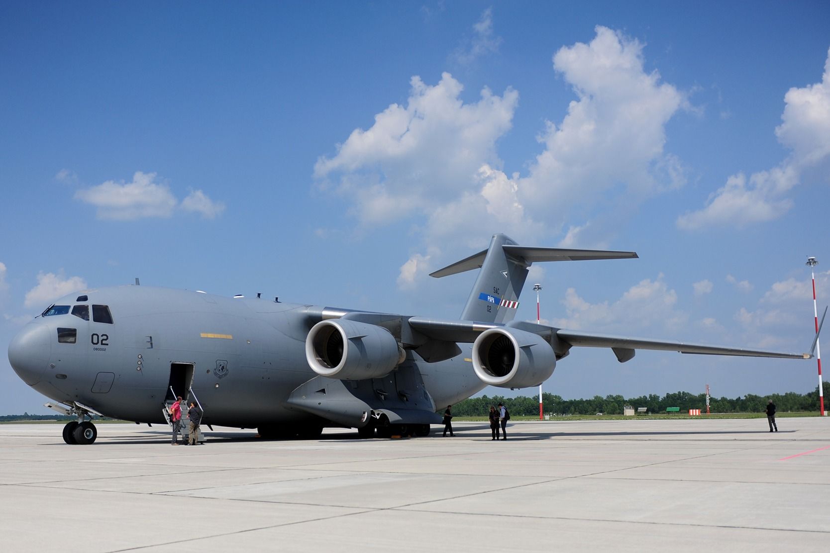 A Boeing C-17 Globemaster parked on an airport apron.