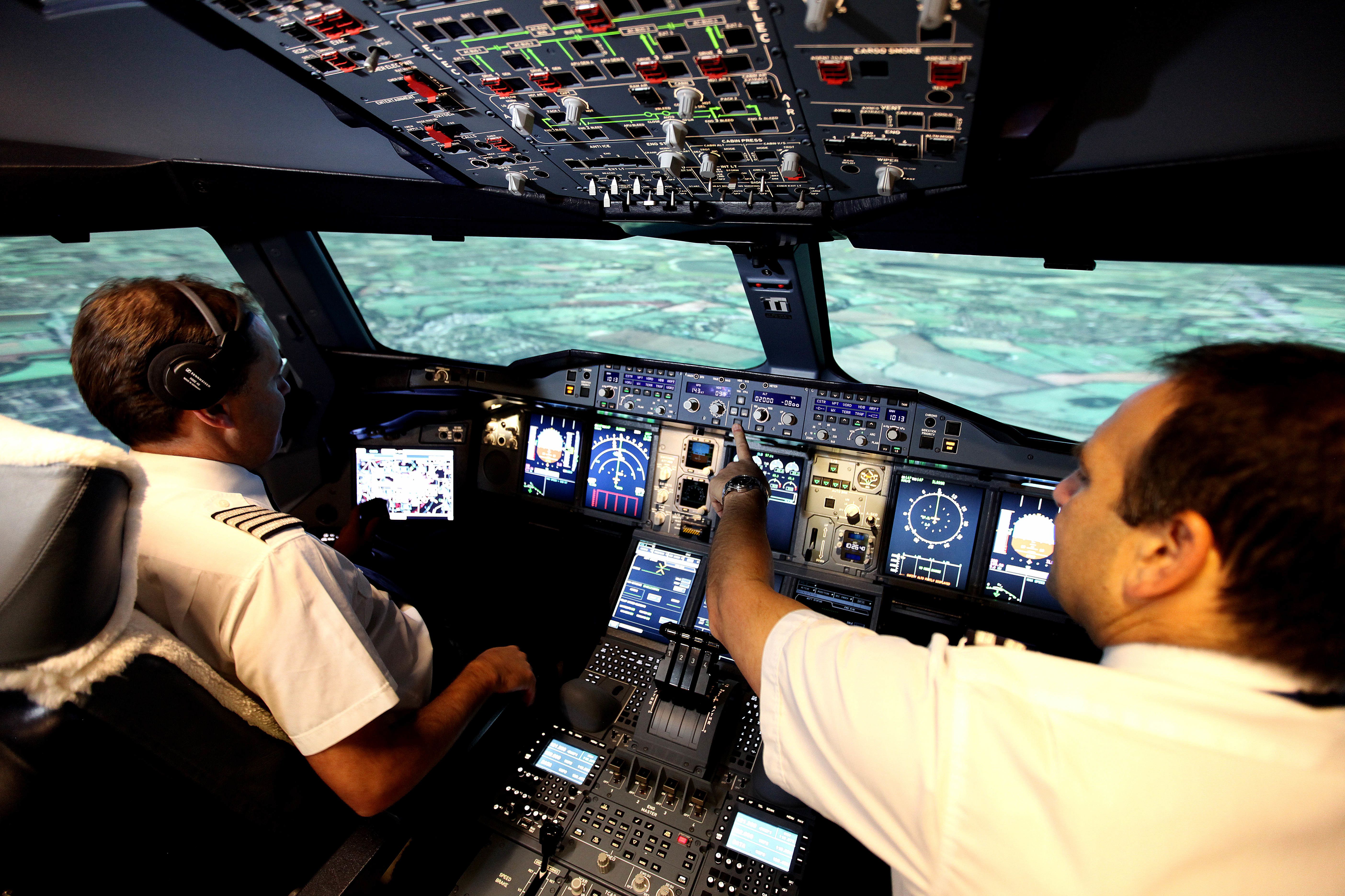 Two pilots on a simulator flight deck