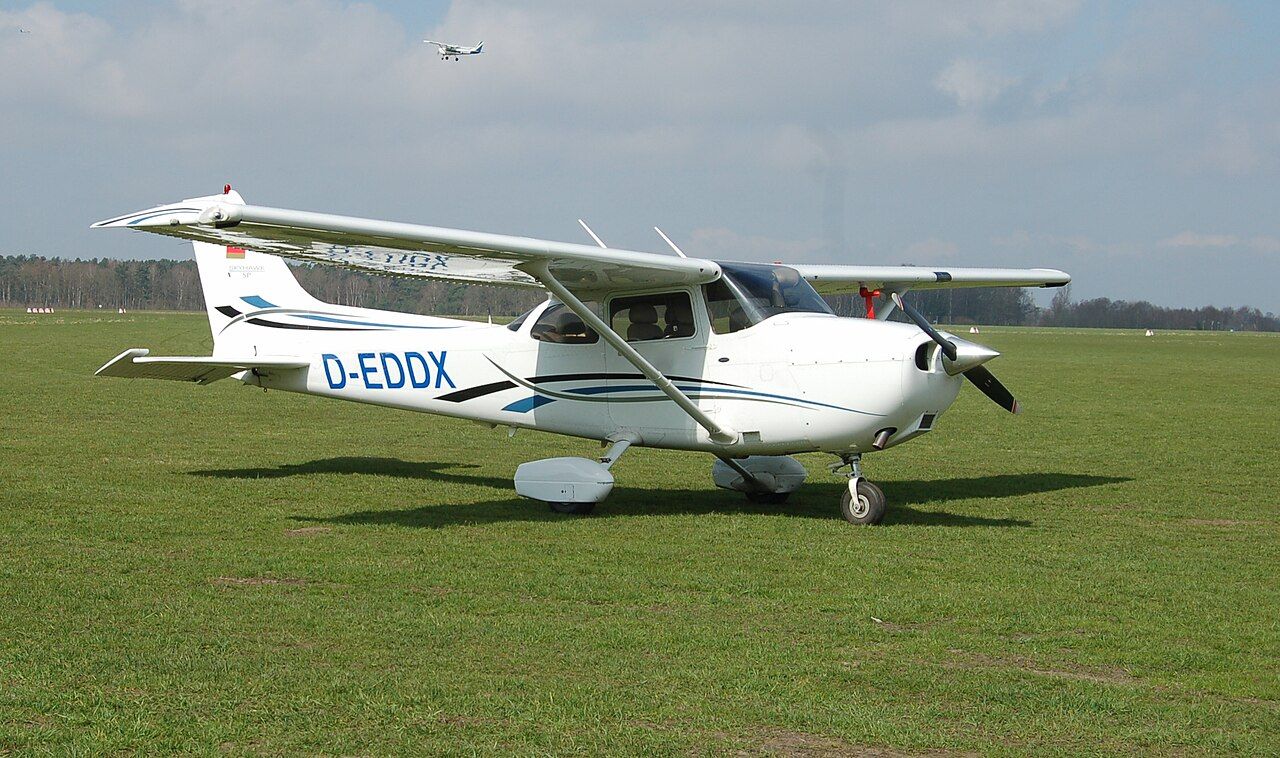 A Cessna 172 Skyhawk parked on grass.