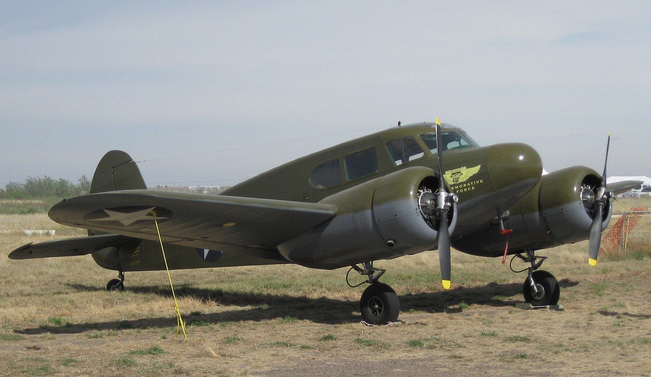 A Cessna T-50 Bobcat parked in a grass field.