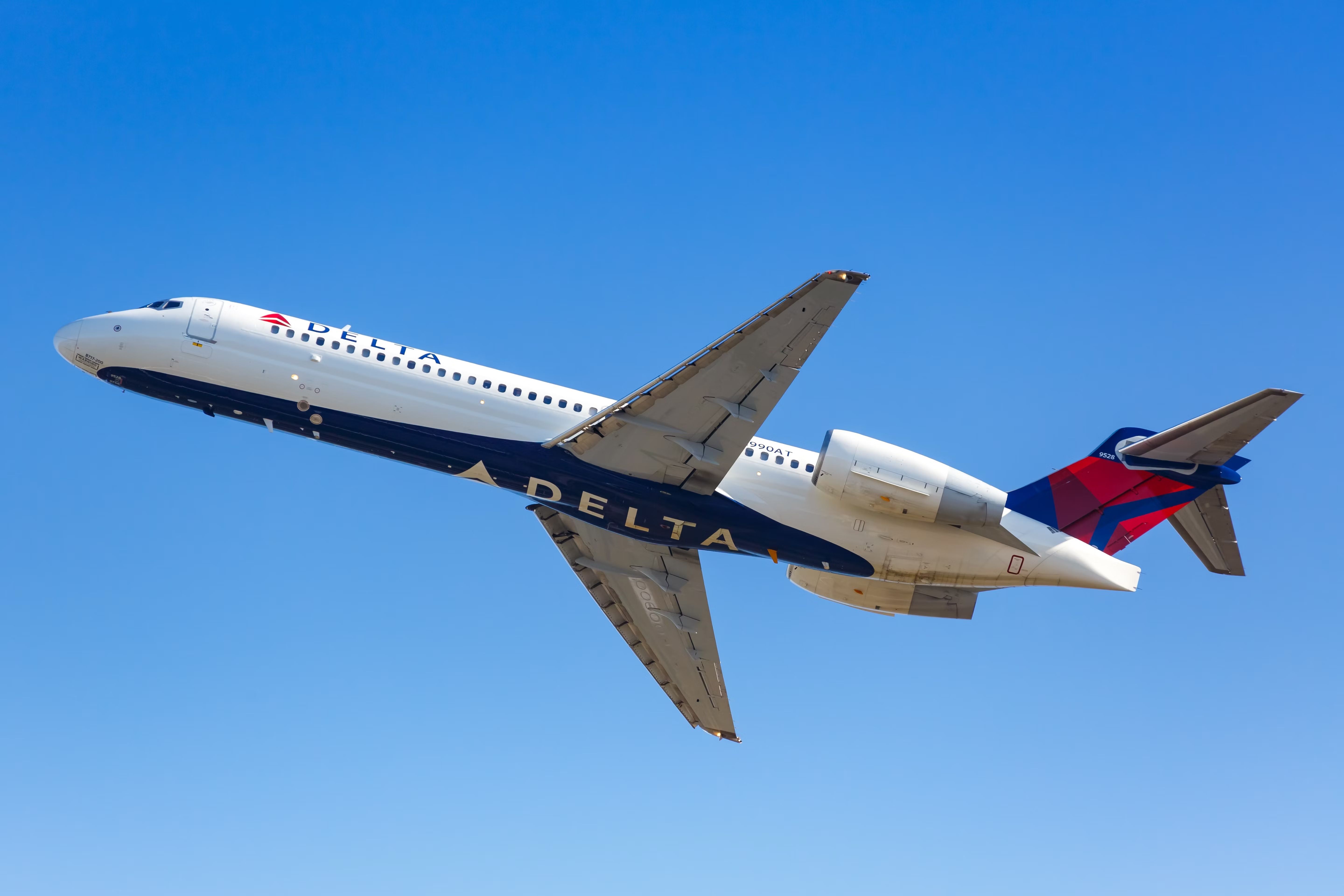 A Delta Air Lines Boeing 717 flying in the sky.