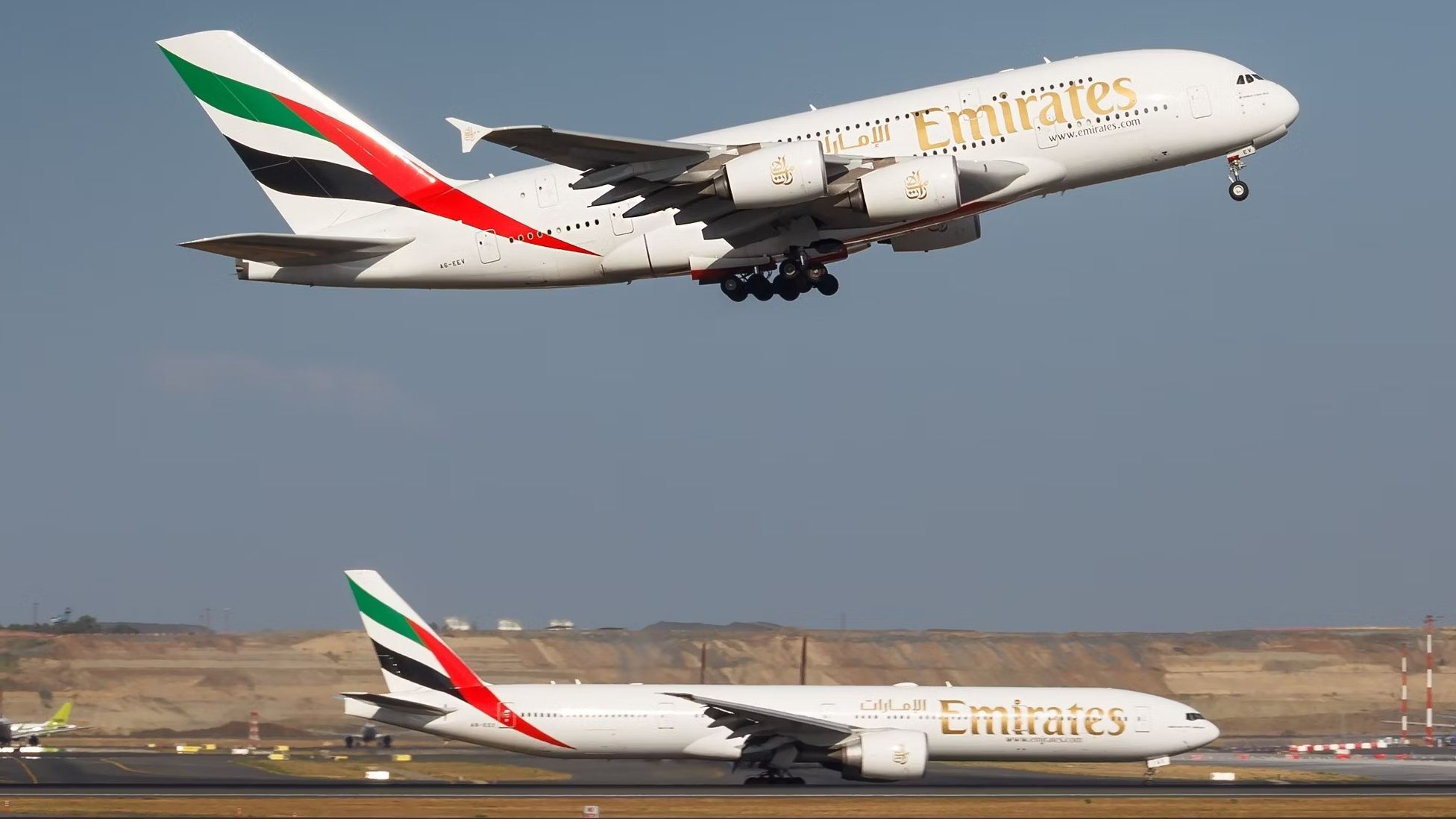 An Emirates Airbus A380 taking off while an Emirates Boeing 777 sits on a taxiway.