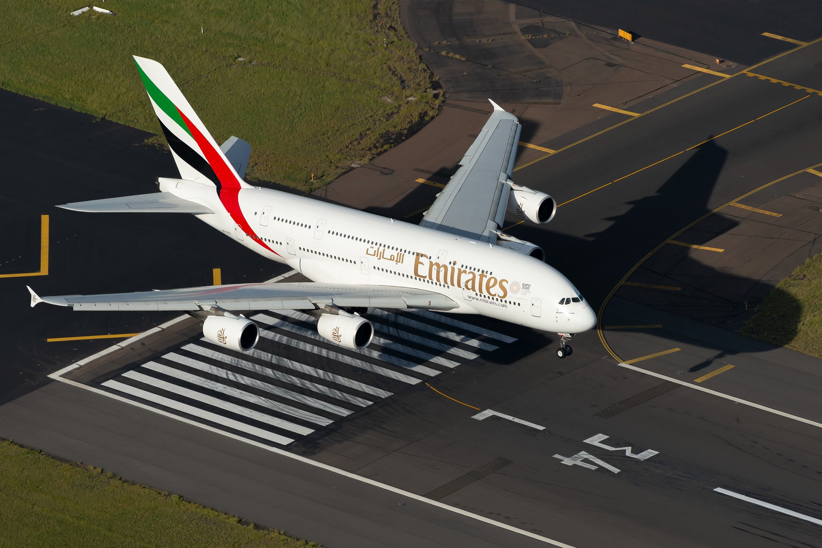 An Emirates Airbus A380 lined up on a runway.