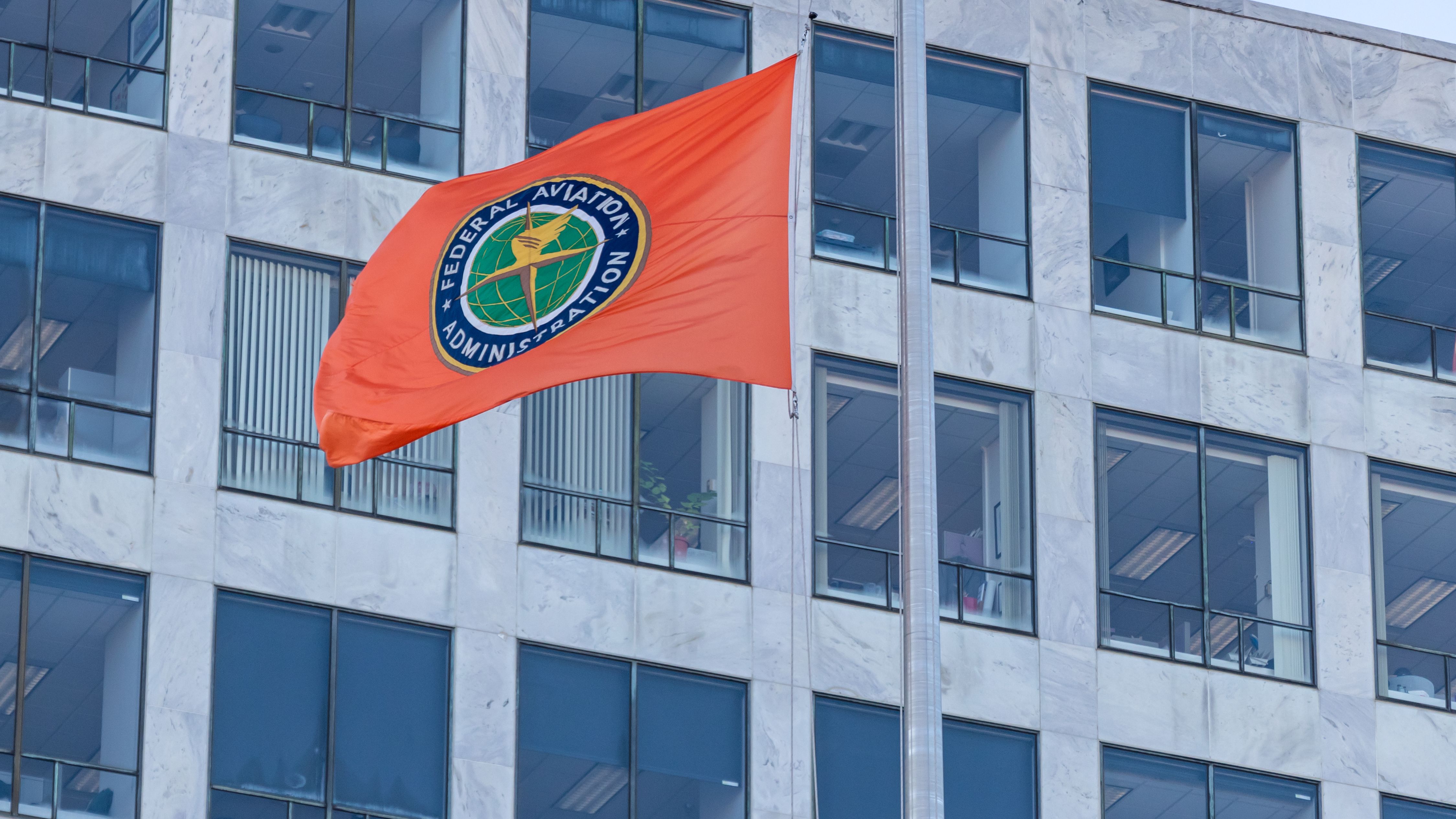 The FAA flag in front of the related government building.