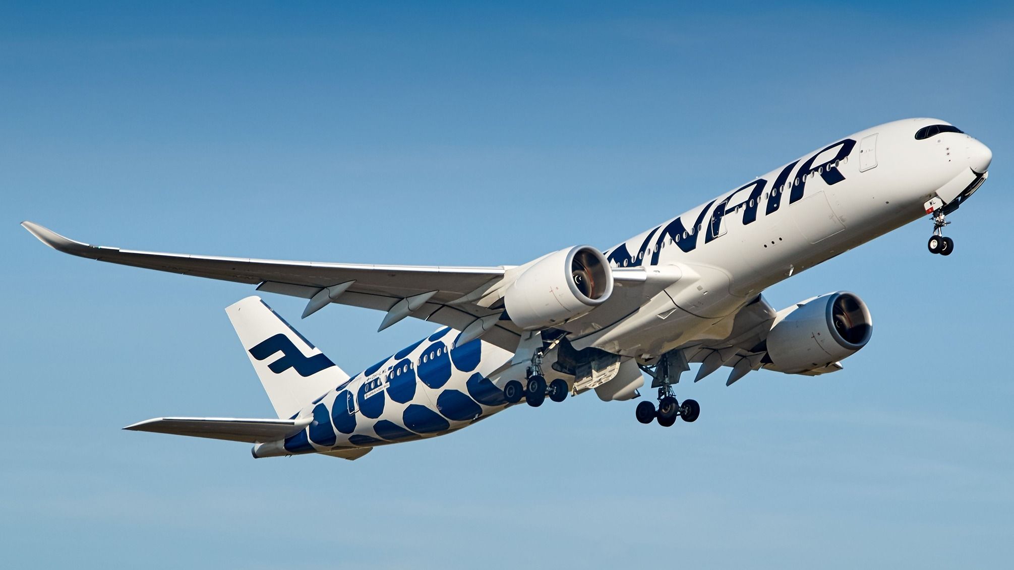 A Finnair Airbus A350 flying in the sky.