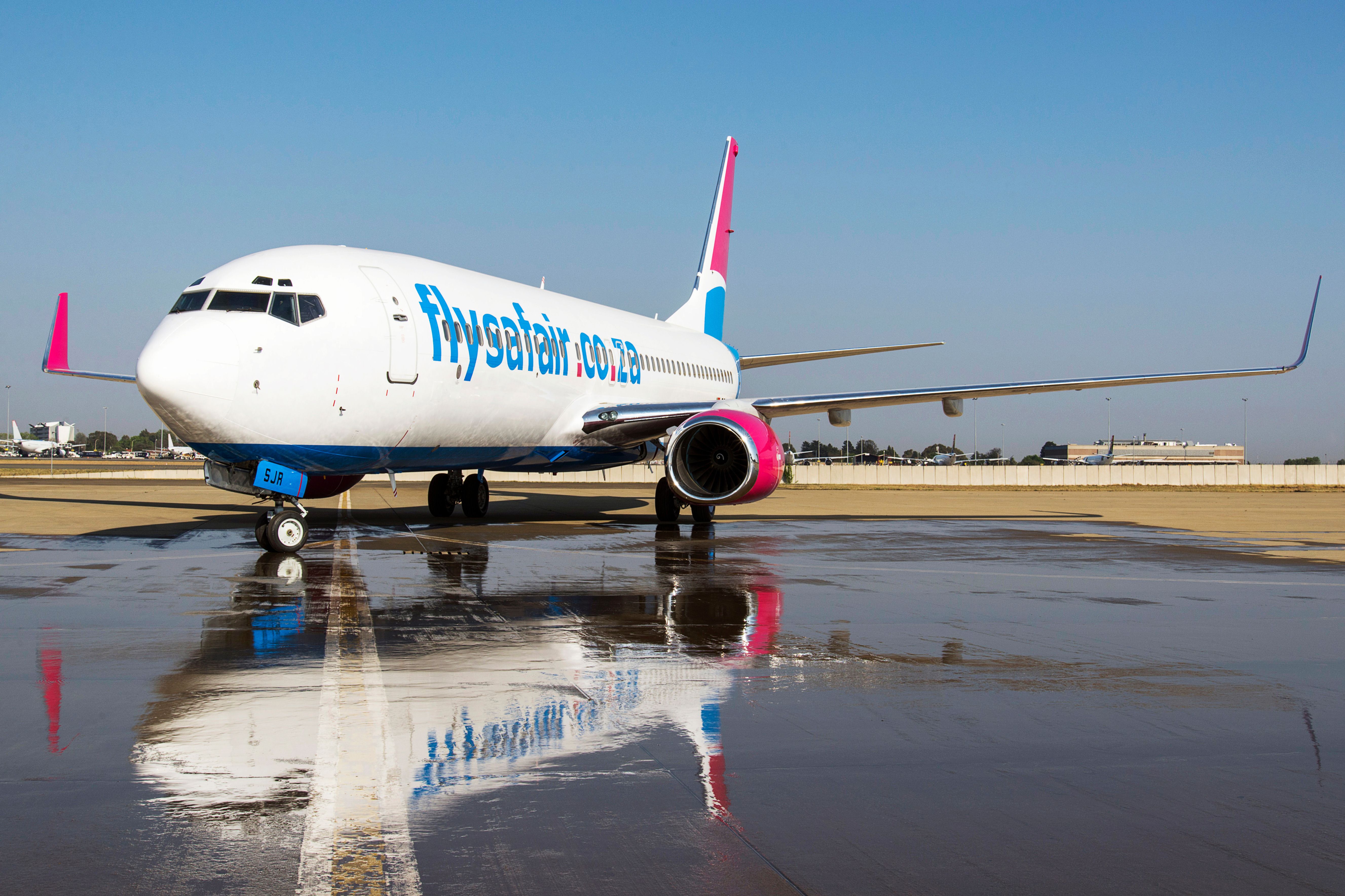 A FlySafair Boeing 737 parked on an airport apron.