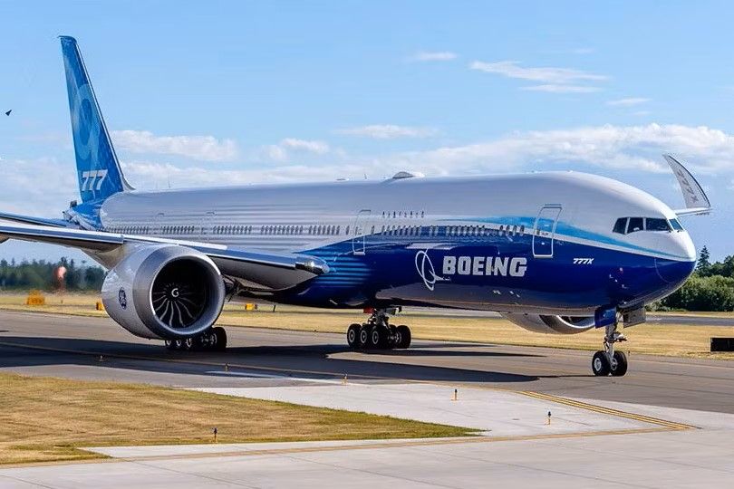 A Boeing 777X on an airport apron.