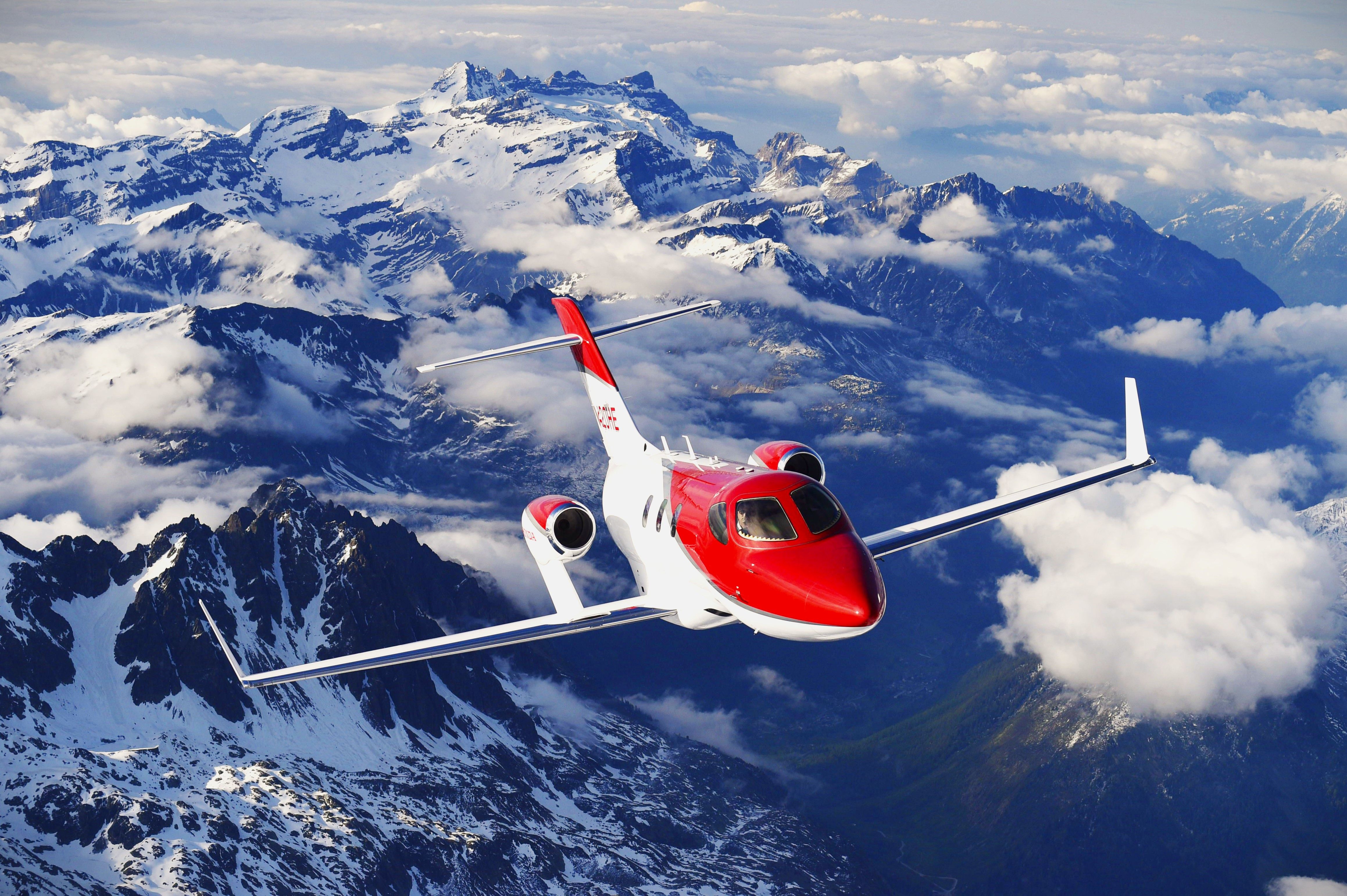 A HondaJet Flying Over The Swiss Alps.
