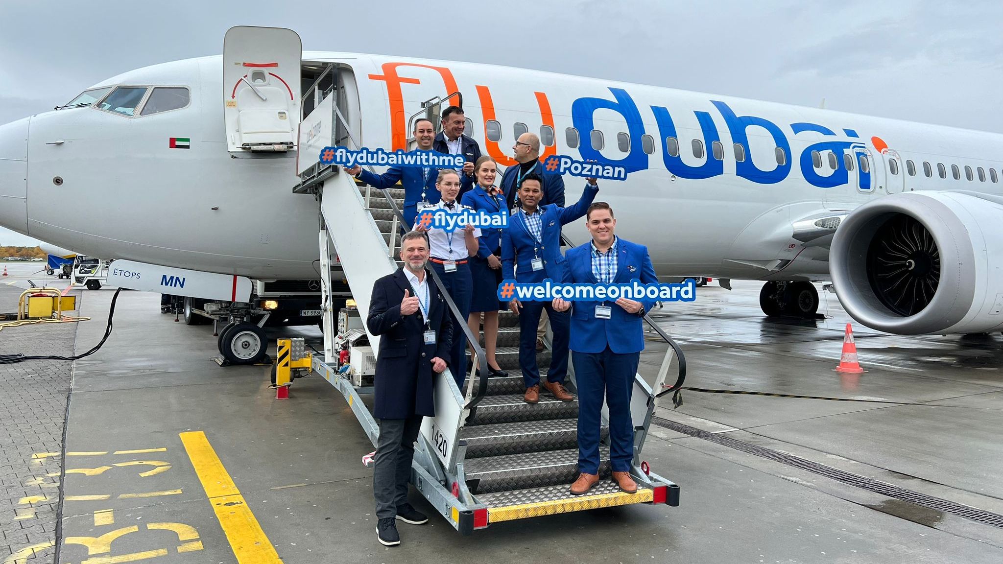 Several flydubai crew standing near an aircraft at Sphinx Airport in Cairo.